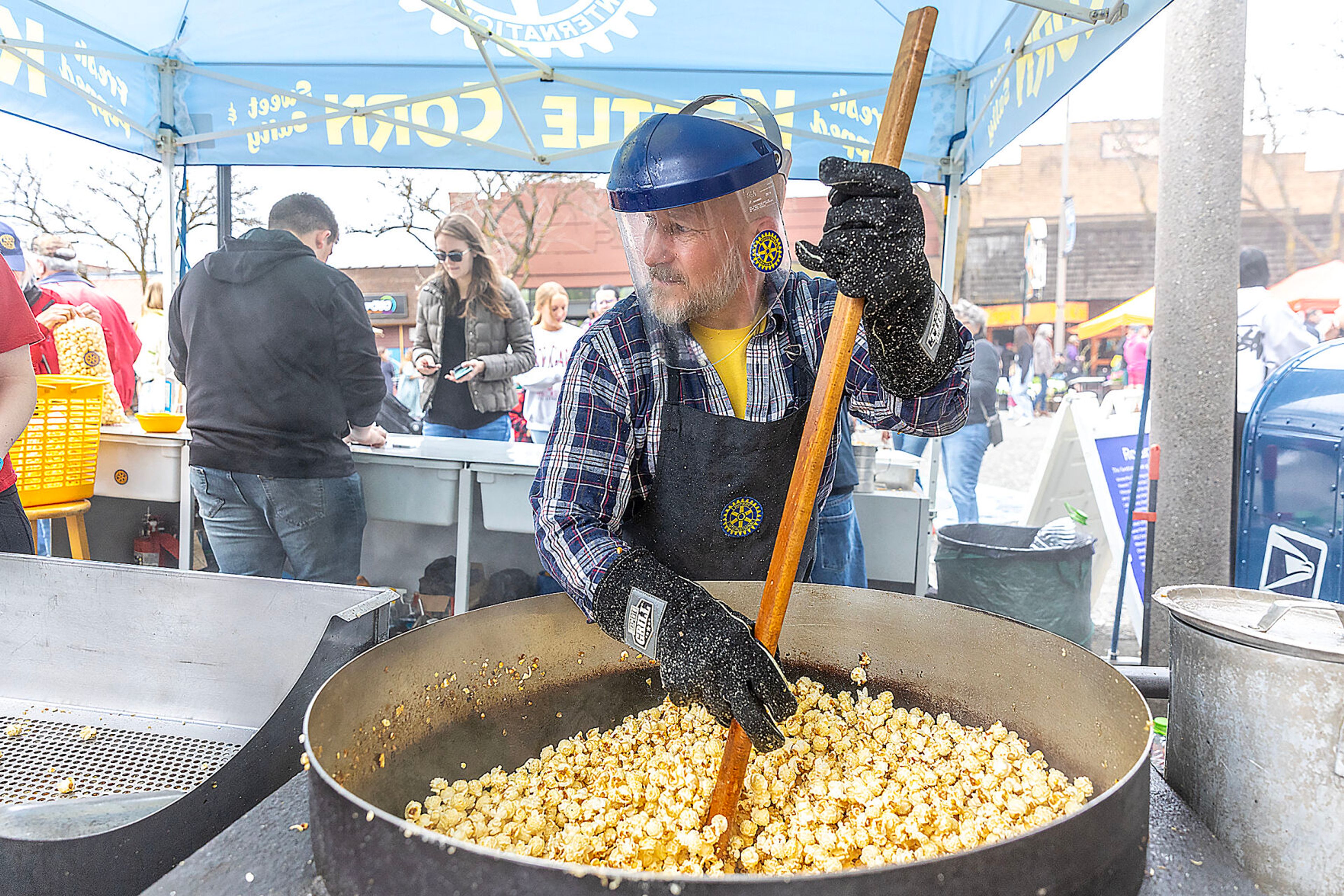 Matt Johnson stirs up a fresh batch of kettle corn for the Rotary Club of Moscow at the Moscow Farmers Market Saturday in Moscow.