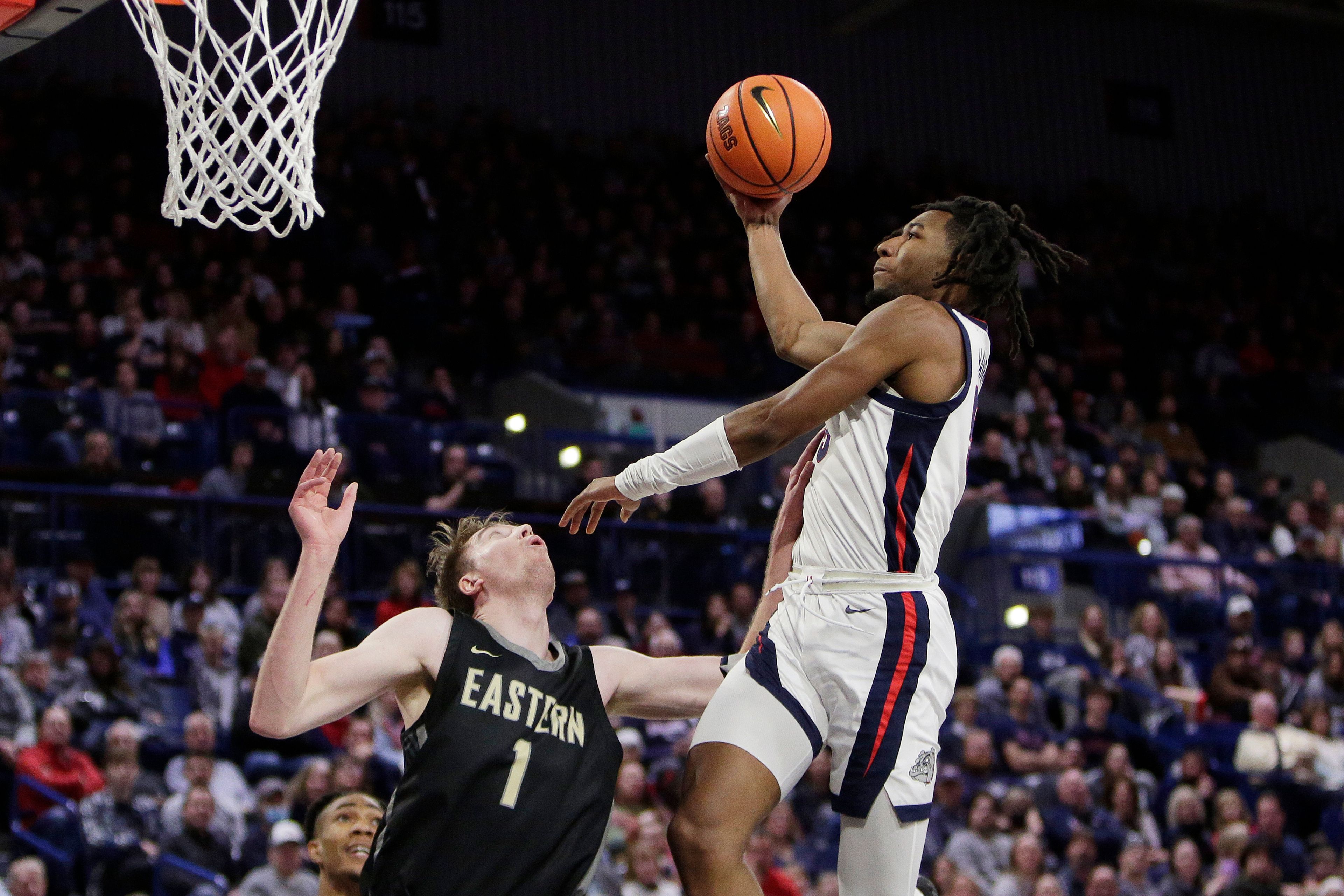 Gonzaga guard Dominick Harris, right, shoots while defended by Eastern Oregon forward Slade Dill during the second half of an NCAA college basketball game Wednesday, Dec. 28, 2022, in Spokane, Wash. Gonzaga won 120-42. (AP Photo/Young Kwak)