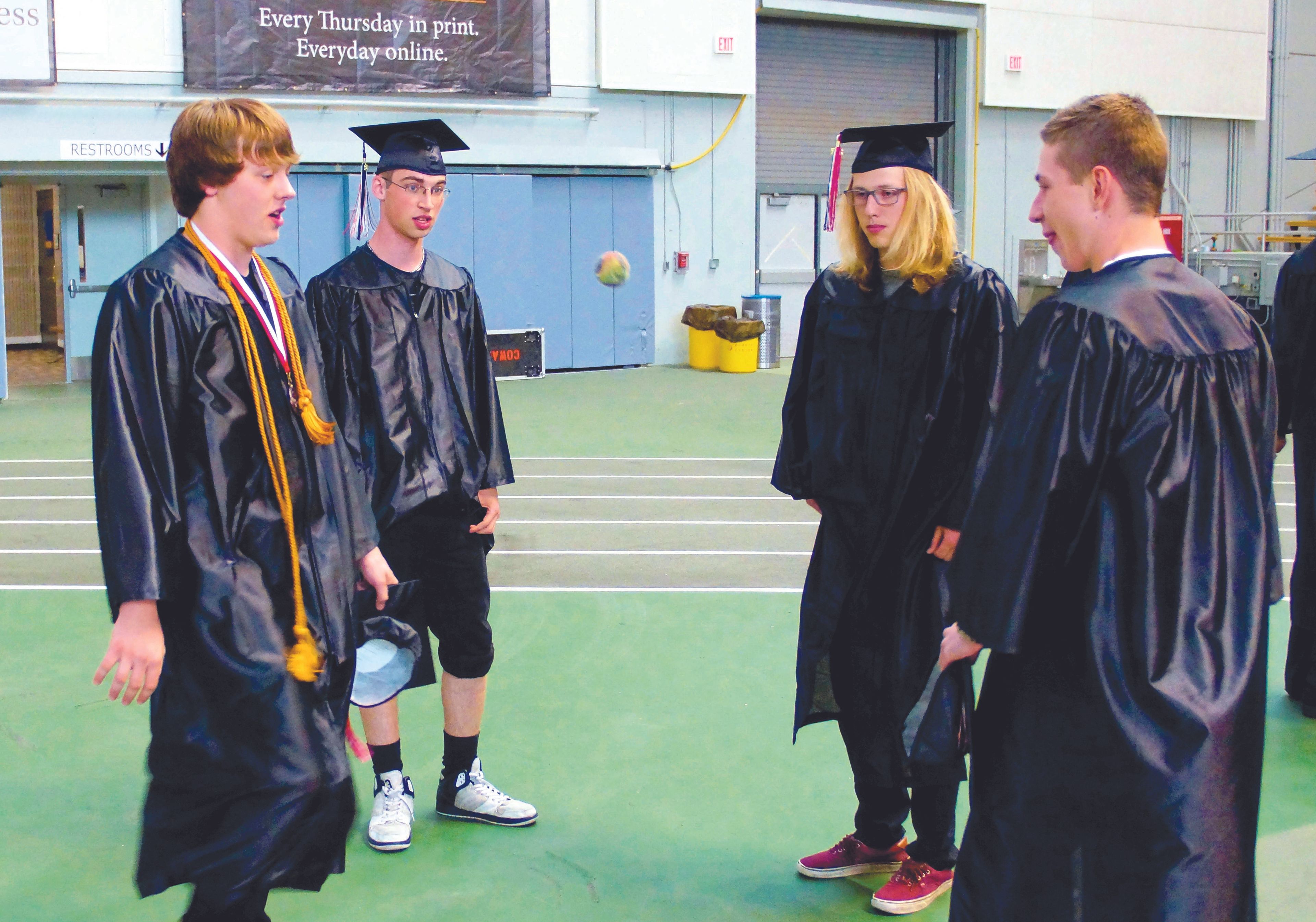 Harlen York, left, Spencer Pope, Michael Goedert and Jacob Cornwall kill time by kicking around a hacky sack before Moscow High School's graduation ceremony in the Kibbie Dome Friday evening.