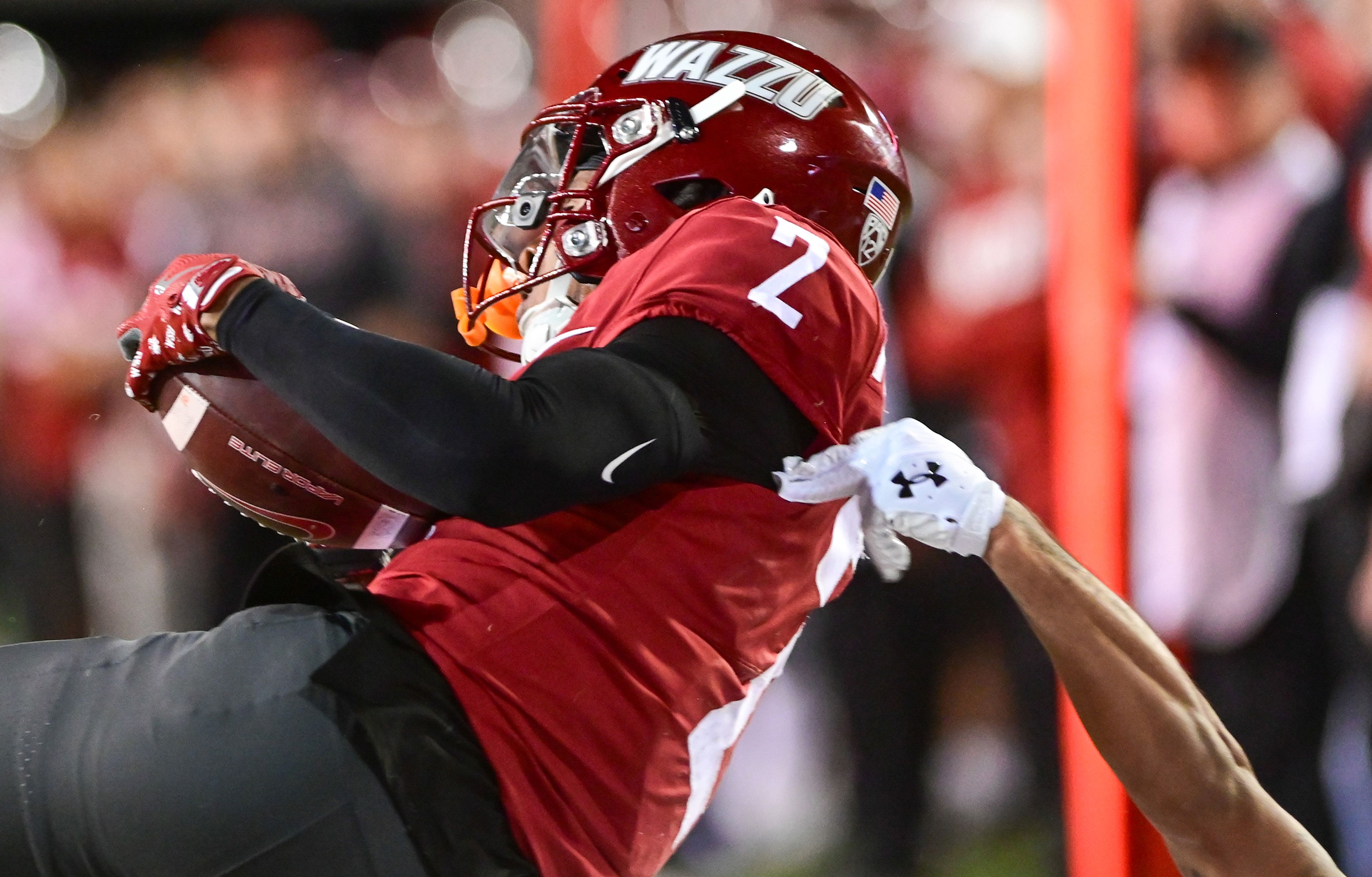 Washington State wide receiver Kyle Williams is pulled to the ground by San Jose State after completing a catch just outside of the end zone Friday in Pullman.,