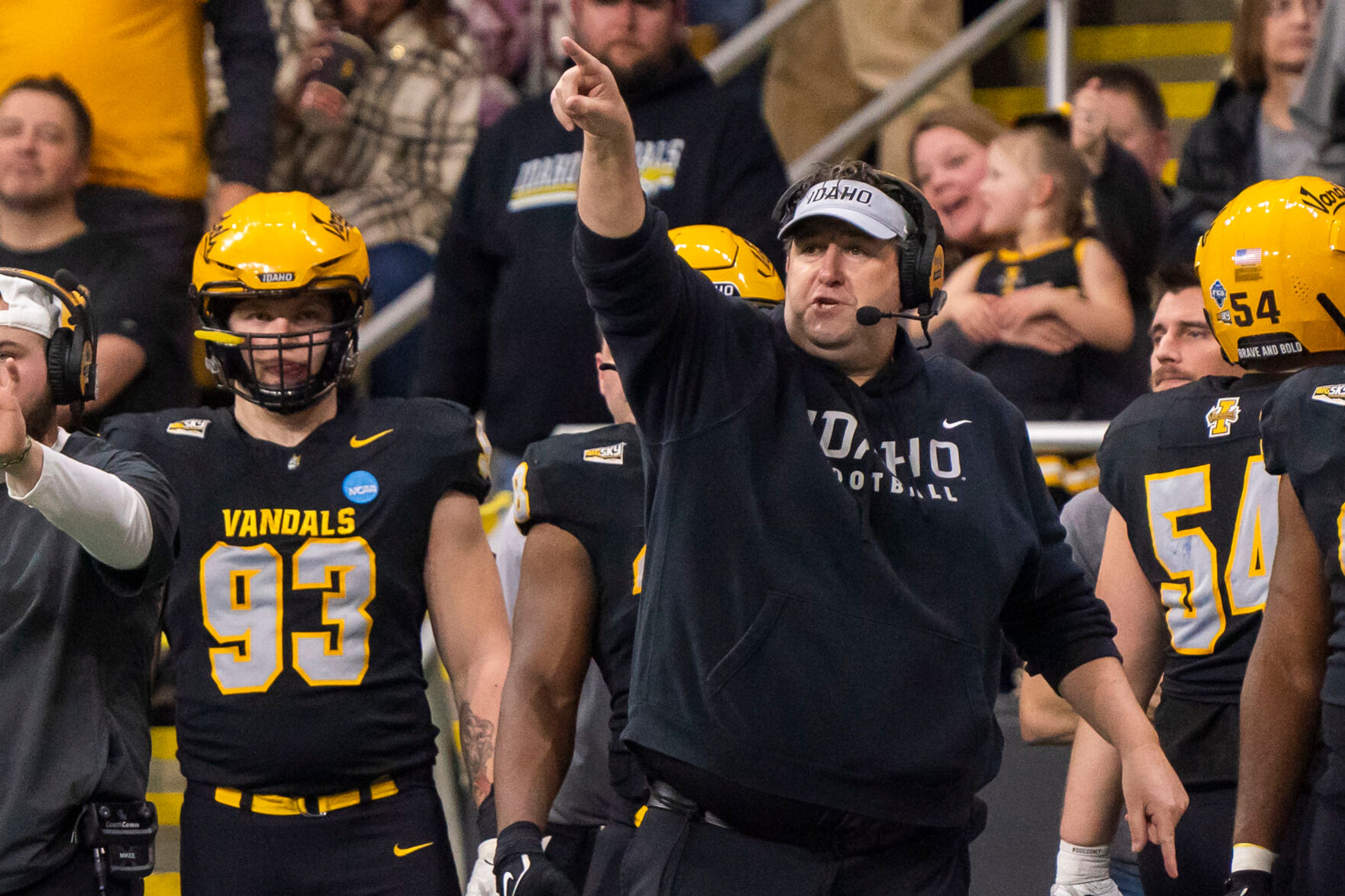 Idaho Vandals head coach Jason Eck points to the Vandal student section after a false start penalty is called on Albany during their game in the third round of the 2023 Division I FCS Football Championship on Saturday inside the Kibbie Dome in Moscow.