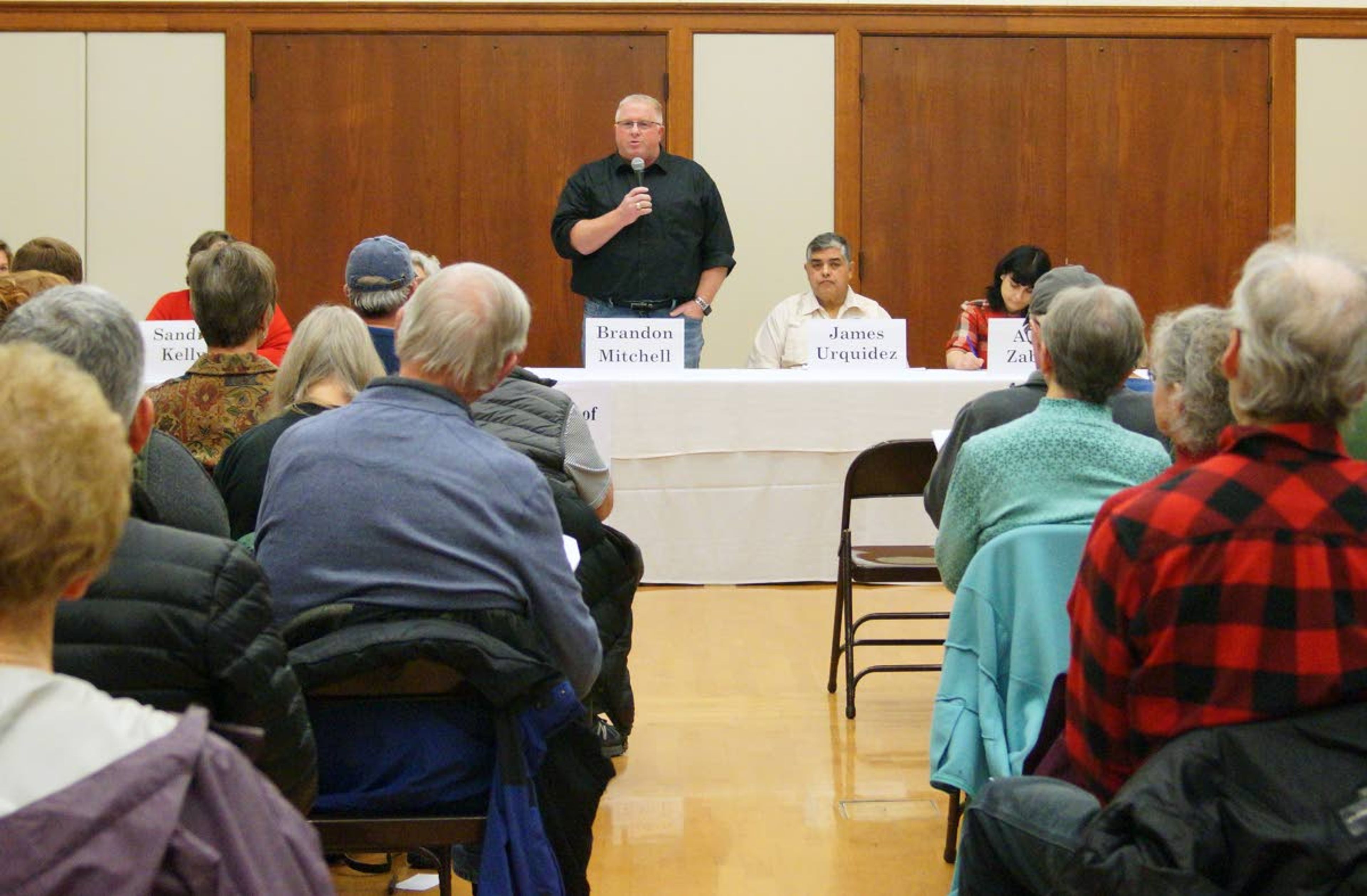 Moscow City Council candidate Brandon Mitchell, standing, speaks during a League of Women Voters candidates forum Wednesday night.