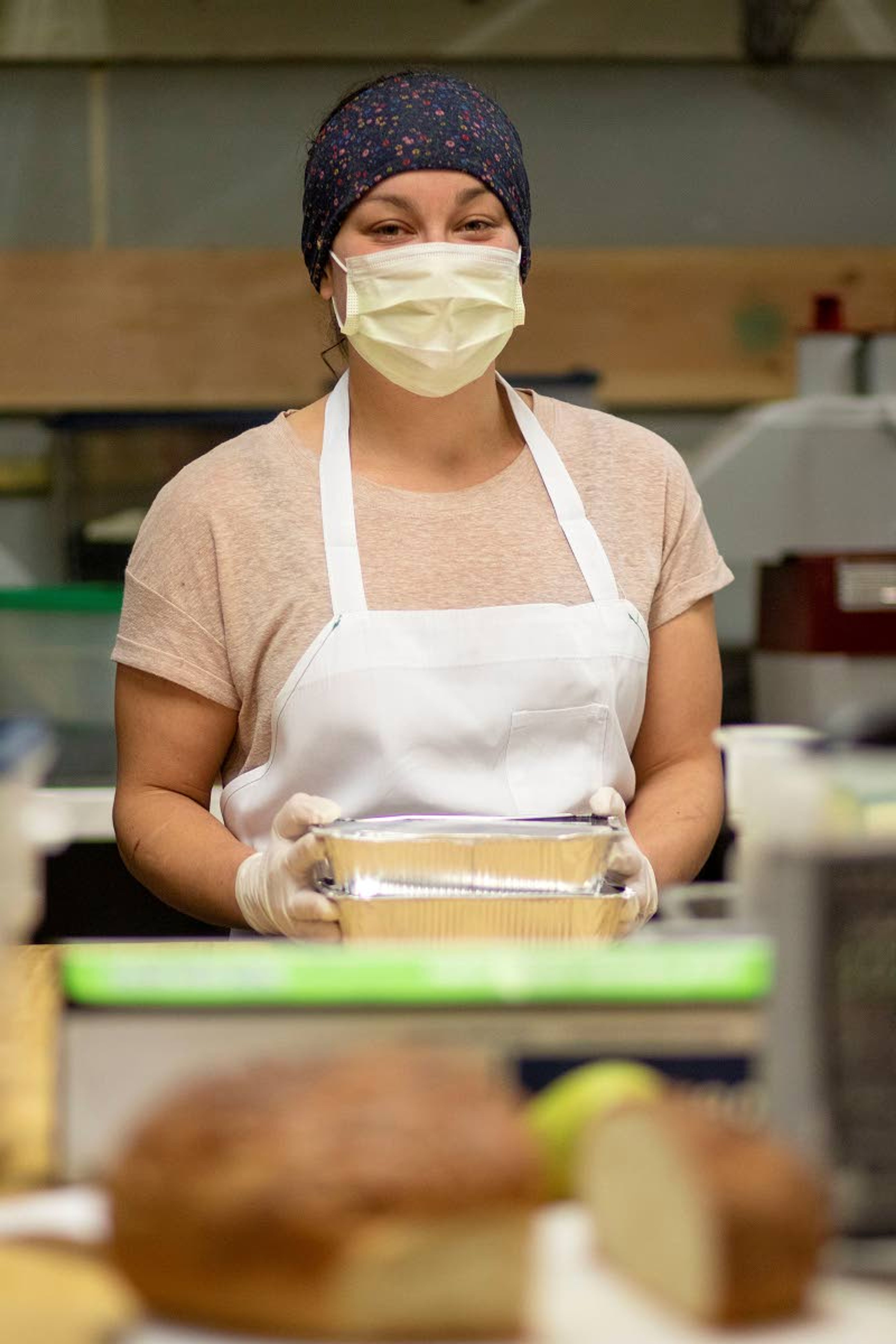 Kitchen Manager Stephanie Wilkes holds a Feed a Family meal on Monday at Bloom Cafe in Moscow. A customer can choose to split the cost of a meal with Bloom to be donated to a family in the Moscow School District.