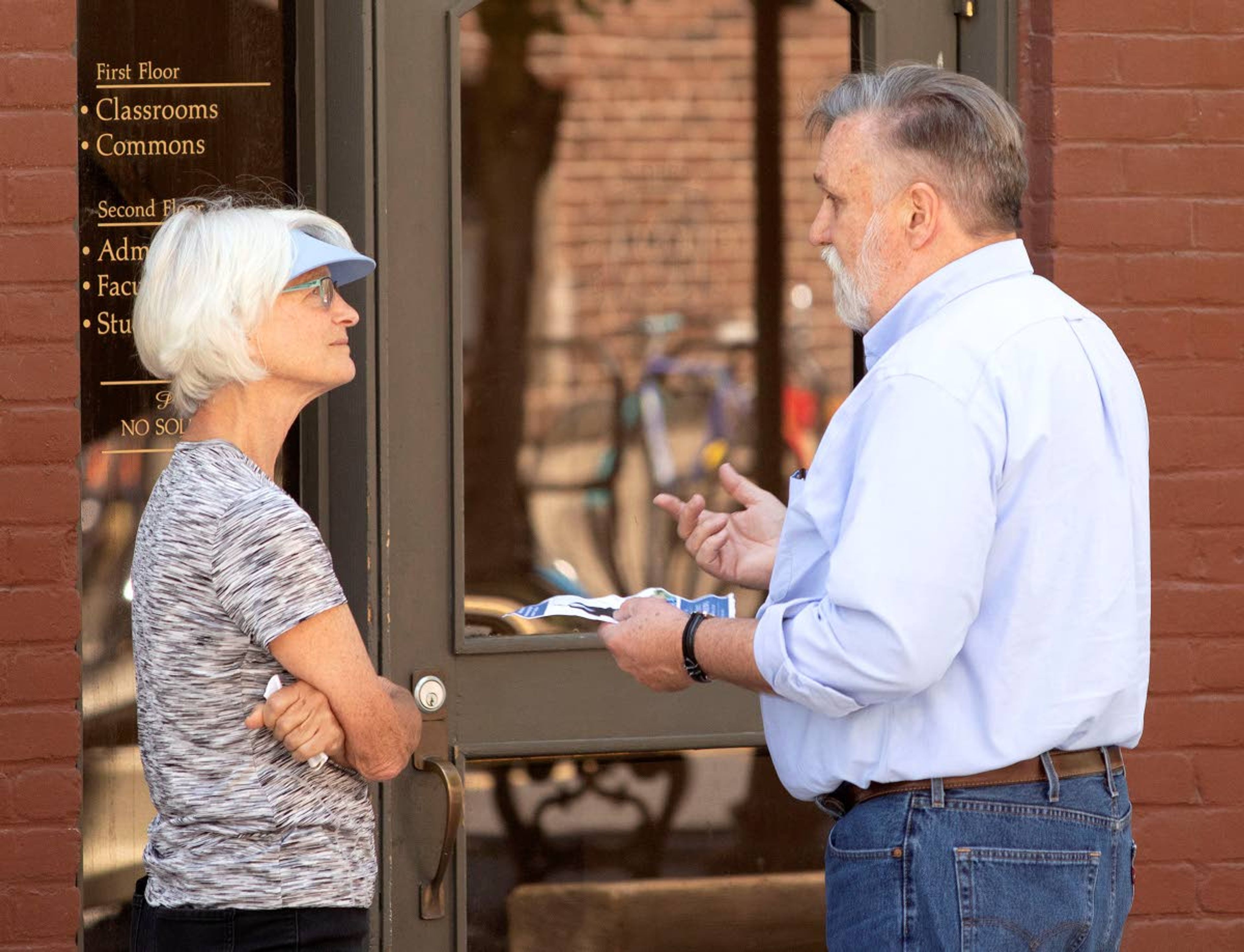 Theresa Beaver of Moscow talks to Moscow pastor Doug Wilson on Friday outside New Saint Andrews College in Moscow. Beaver was asking Wilson about a flyer which quoted him as saying, ""We know that sodomy is worse than slavery by how god responds to it."