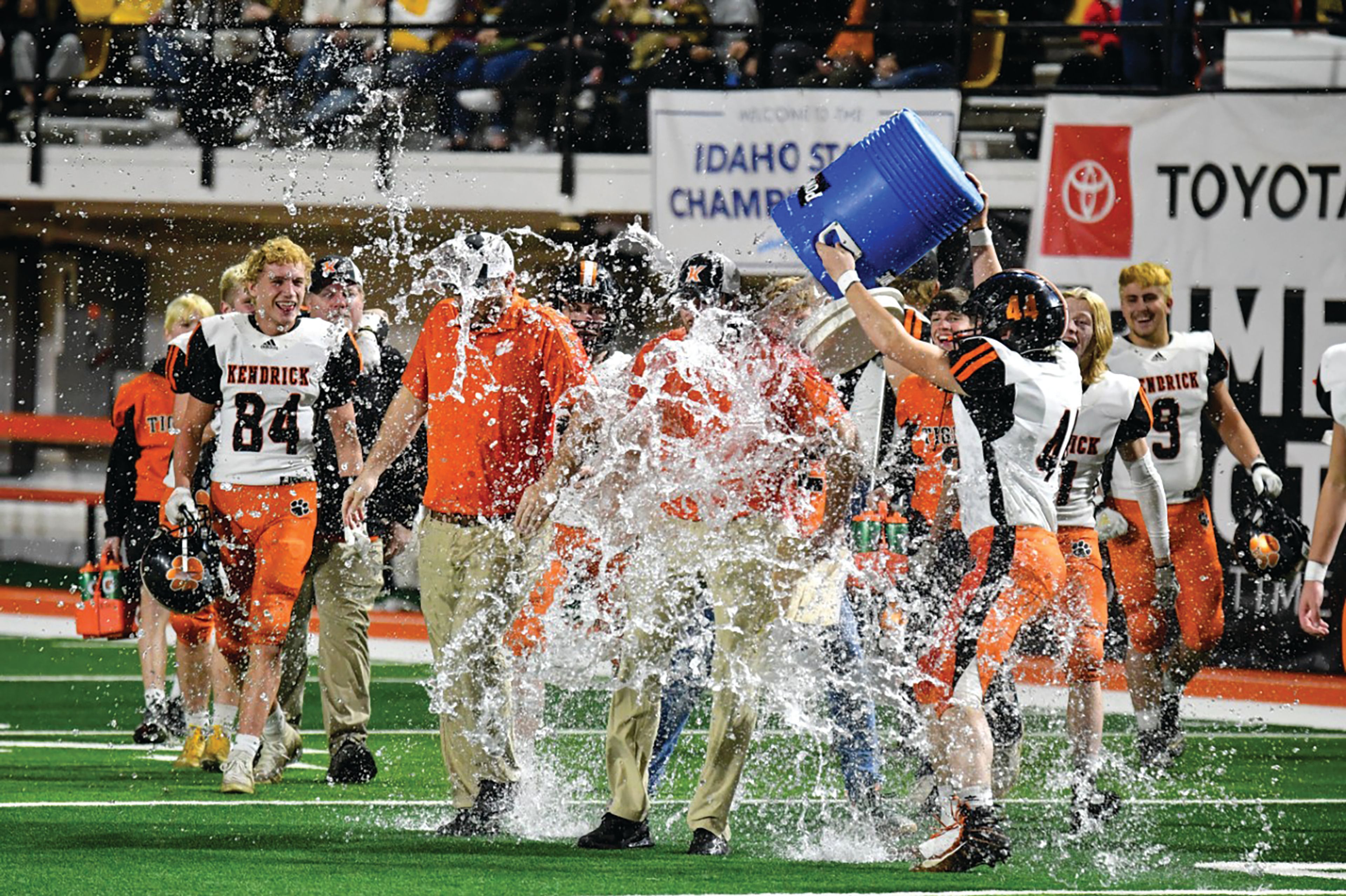 Scott Kirtley/For The Tribune Kendrick football coach Zane Hobart is drenched with water after the Tigers beat Dietrich 42-34 in Friday's Idaho Class 1A Division II football state championship game at Holt Arena in Pocatello.