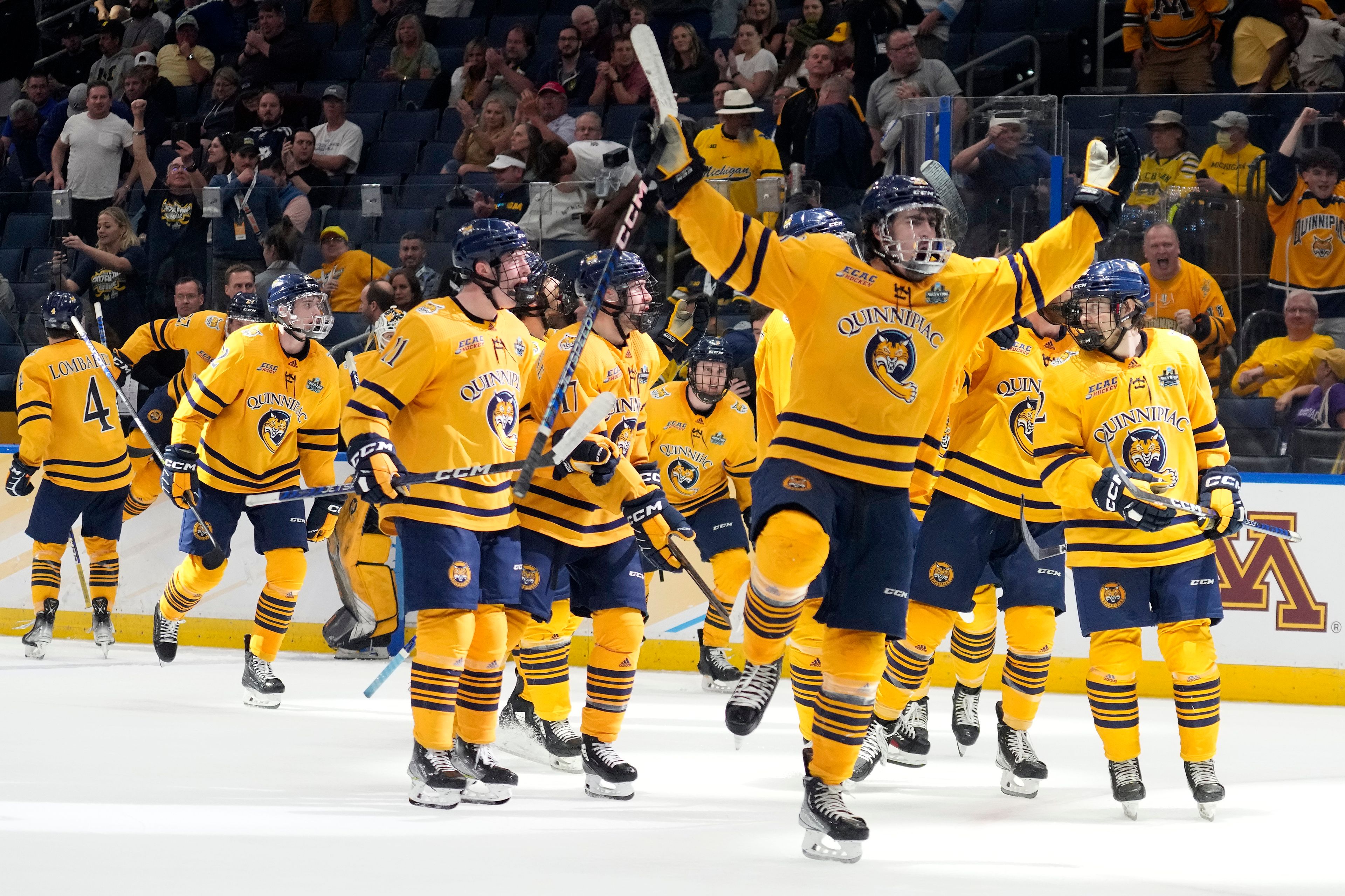 Quinnipiac players celebrate after the team defeated Michigan during an NCAA semifinal game in the Frozen Four college hockey tournament Thursday, April 6, 2023, in Tampa, Fla. (AP Photo/Chris O'Meara)