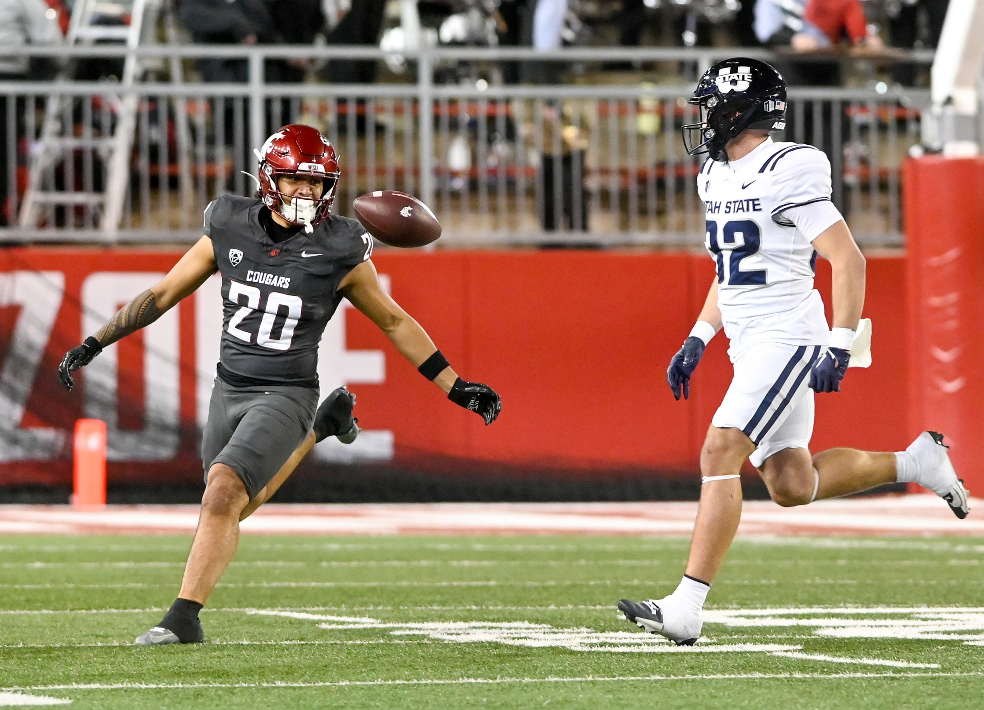 The ball bounces in front of Washington State running back Leo Pulalasi (20) after an incomplete pass intended for Pulalasi during a game against Utah State Saturday at Gesa Field in Pullman.