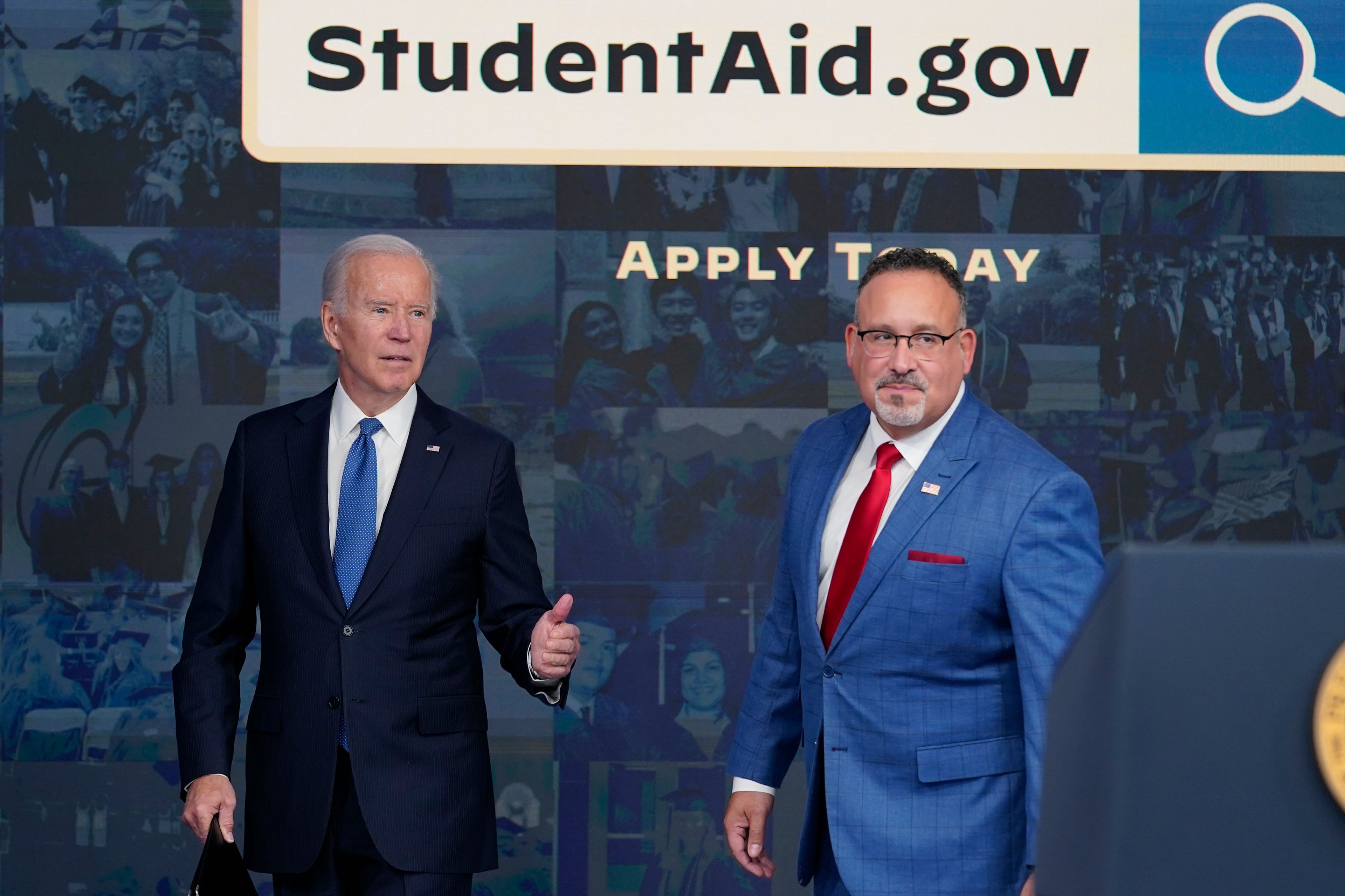 President Joe Biden answers questions with Education Secretary Miguel Cardona as they leave an event about the student debt relief portal beta test in the South Court Auditorium on the White House complex in Washington, Monday, Oct. 17, 2022. (AP Photo/Susan Walsh)