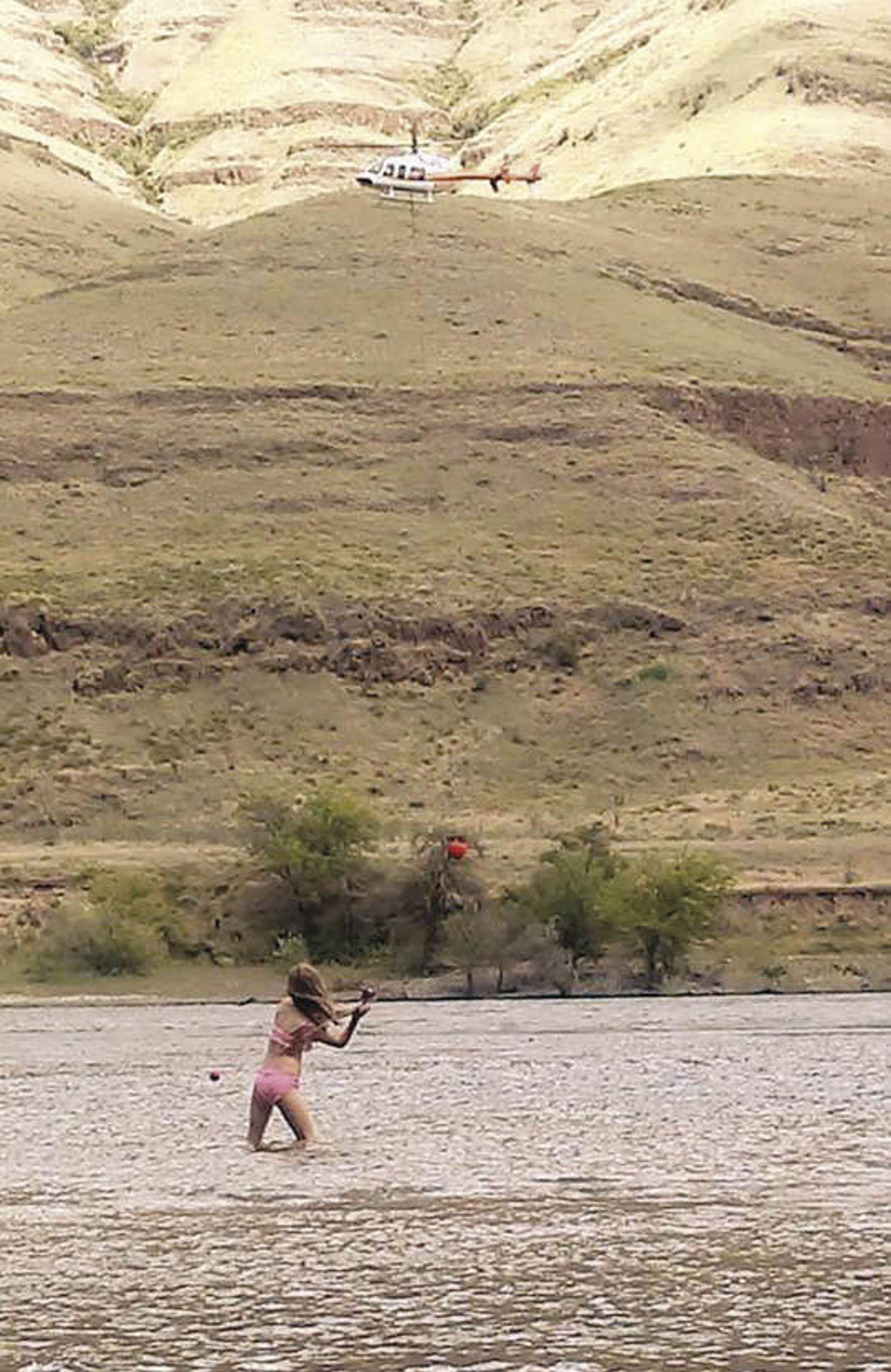 Katie Gustafson submitted this June 23 photo of her daughter, Sophia, fishing while a helicopter flew overhead to Inland 360’s “Share Your Snaps,” an online community photo album.