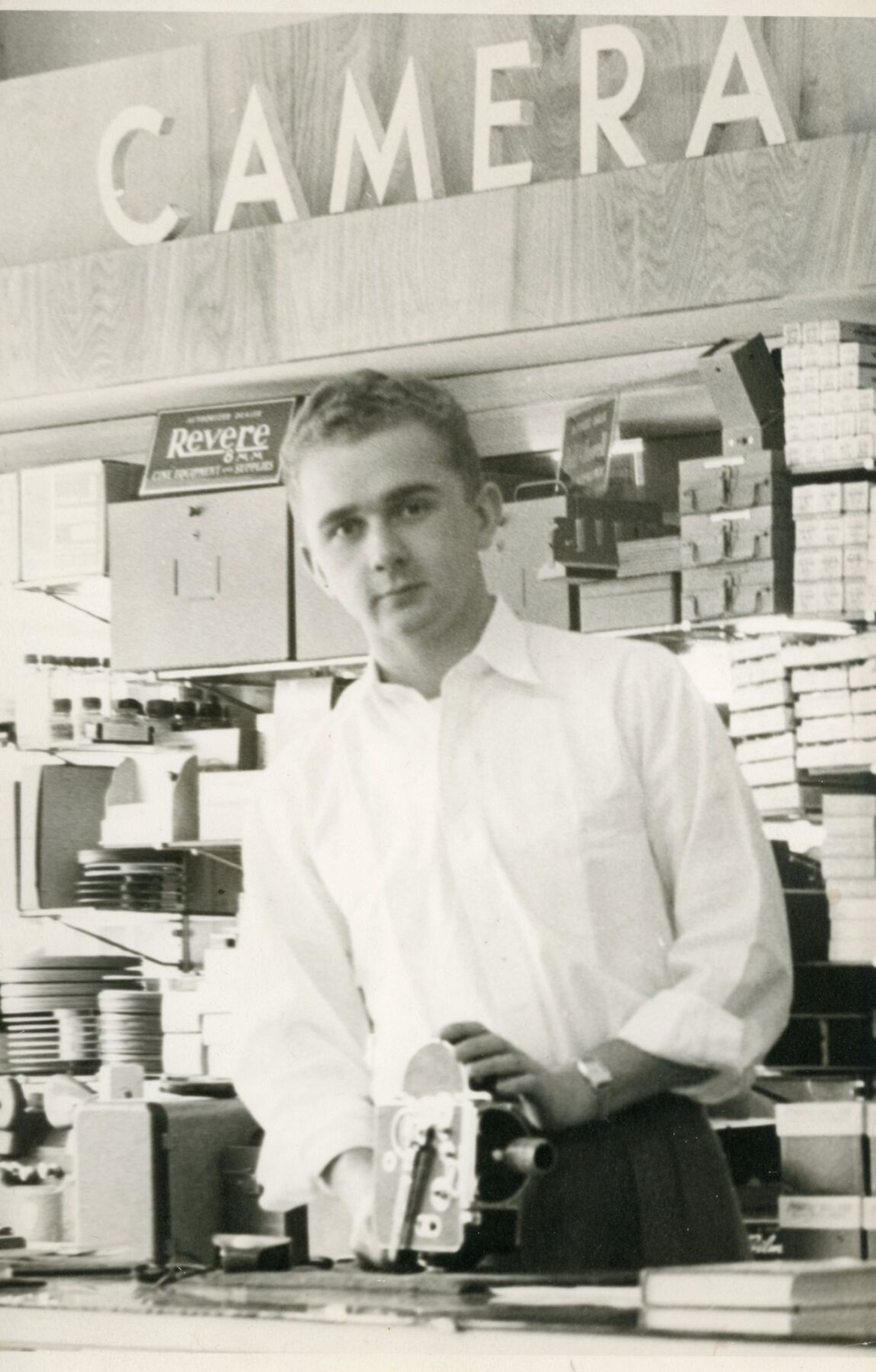 Cliff Wasem, an owner of Wasem's Pharmacy & Home Medical in Clarkston for more than a half century, poses with camera equipment at the store in the 1950s