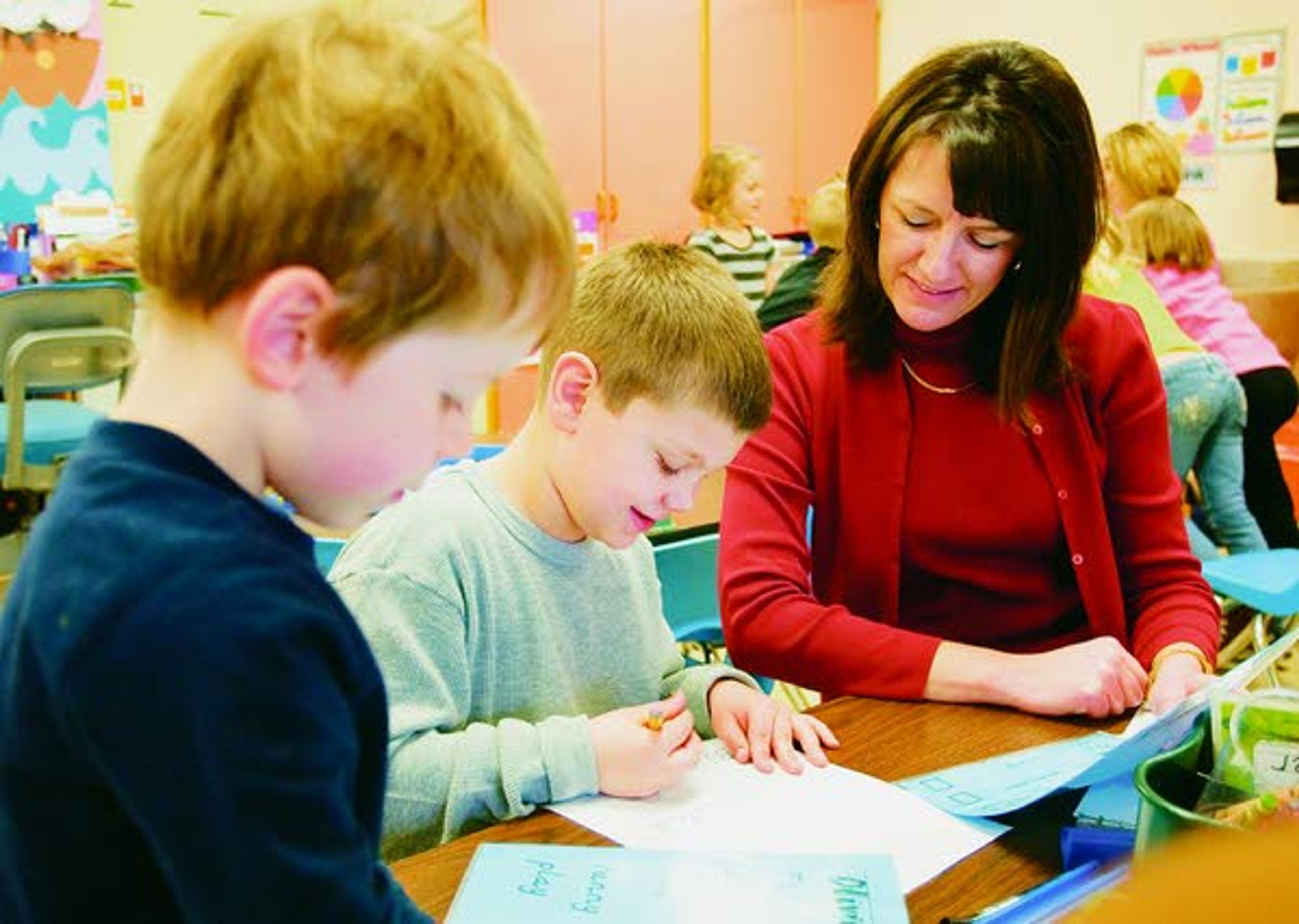 Principal Kendra McMillan works with kindergartners Young Clevenger, left, and Logan Miller at Lena Whitmore Elementary School in Moscow on Wednesday. McMillian recently received an Idaho Gem Award from the Idaho Association of Elementary School Principals.