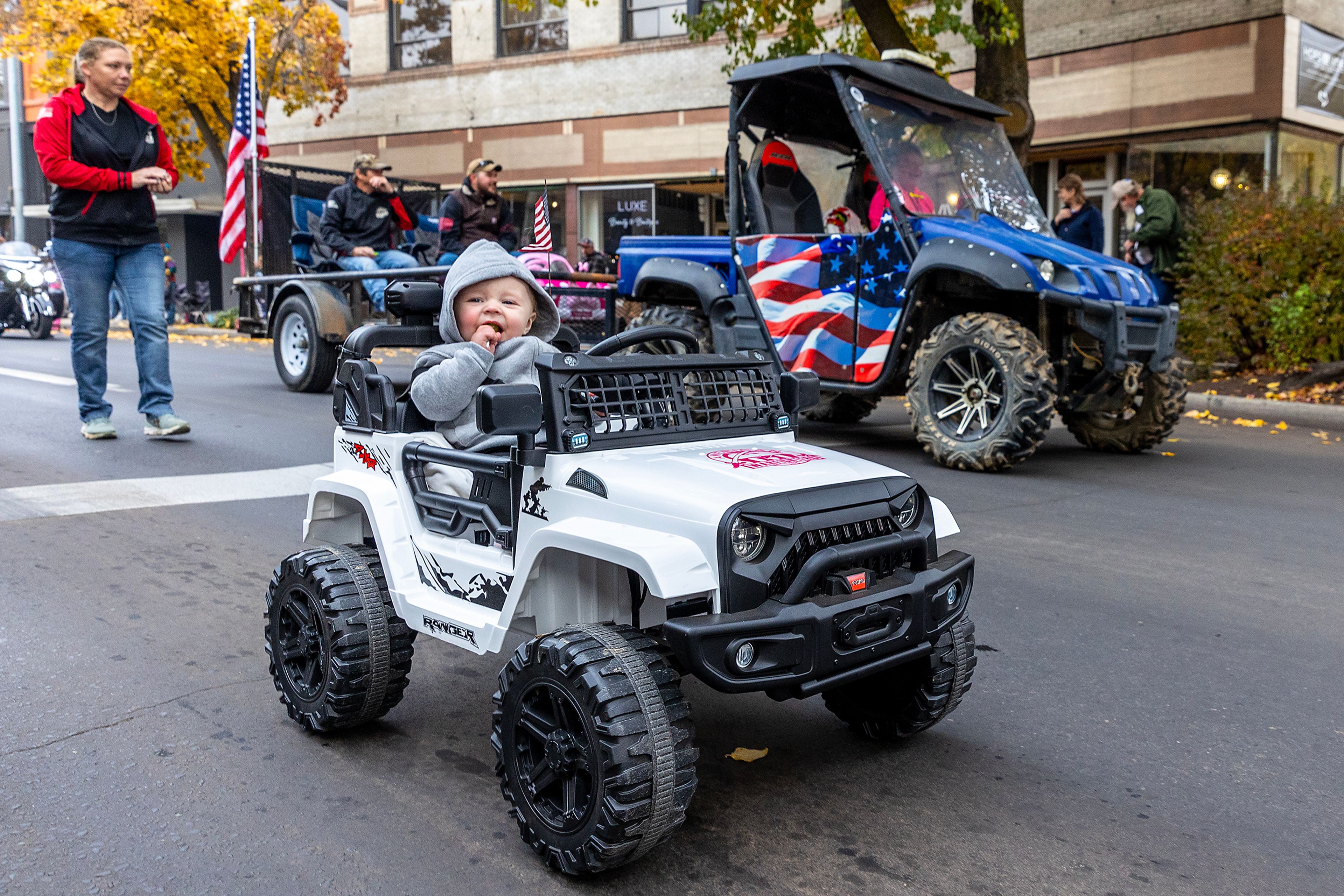 A baby rides in style Saturday at the Veteran’s Day Parade on Main Street in Lewiston.