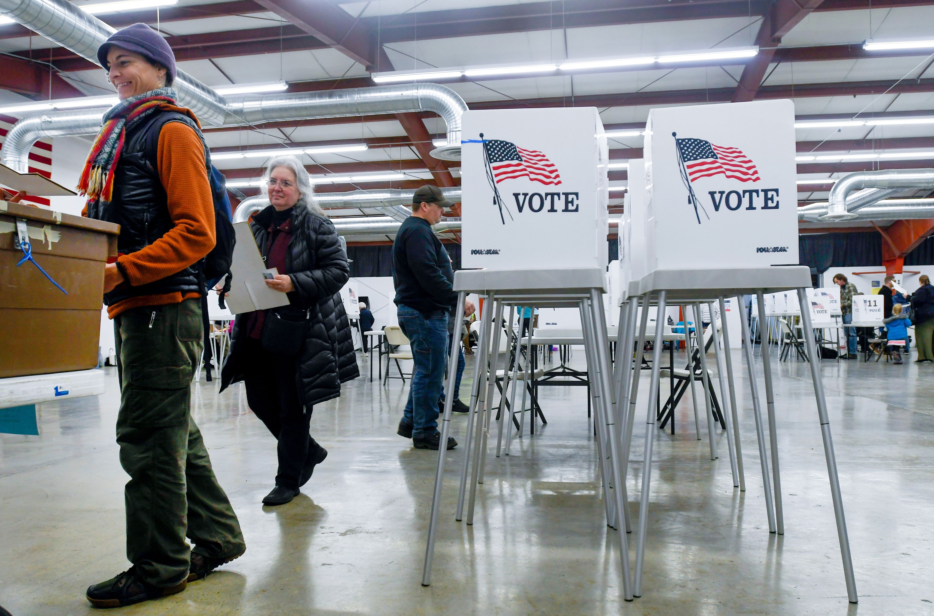 Allison Jackson, left, carries a filled out ballot to a drop box at the Latah County Fairgrounds in Moscow on Election Day.