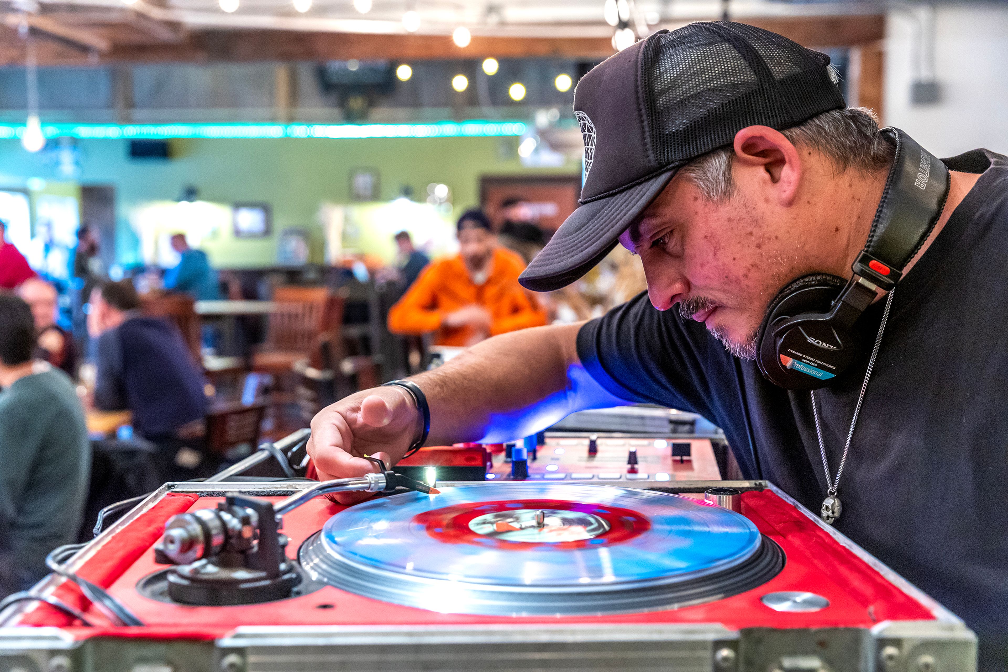 David Campillo sets needle in place during Bring Your Own Vinyl Night at Moscow Brewing Company.