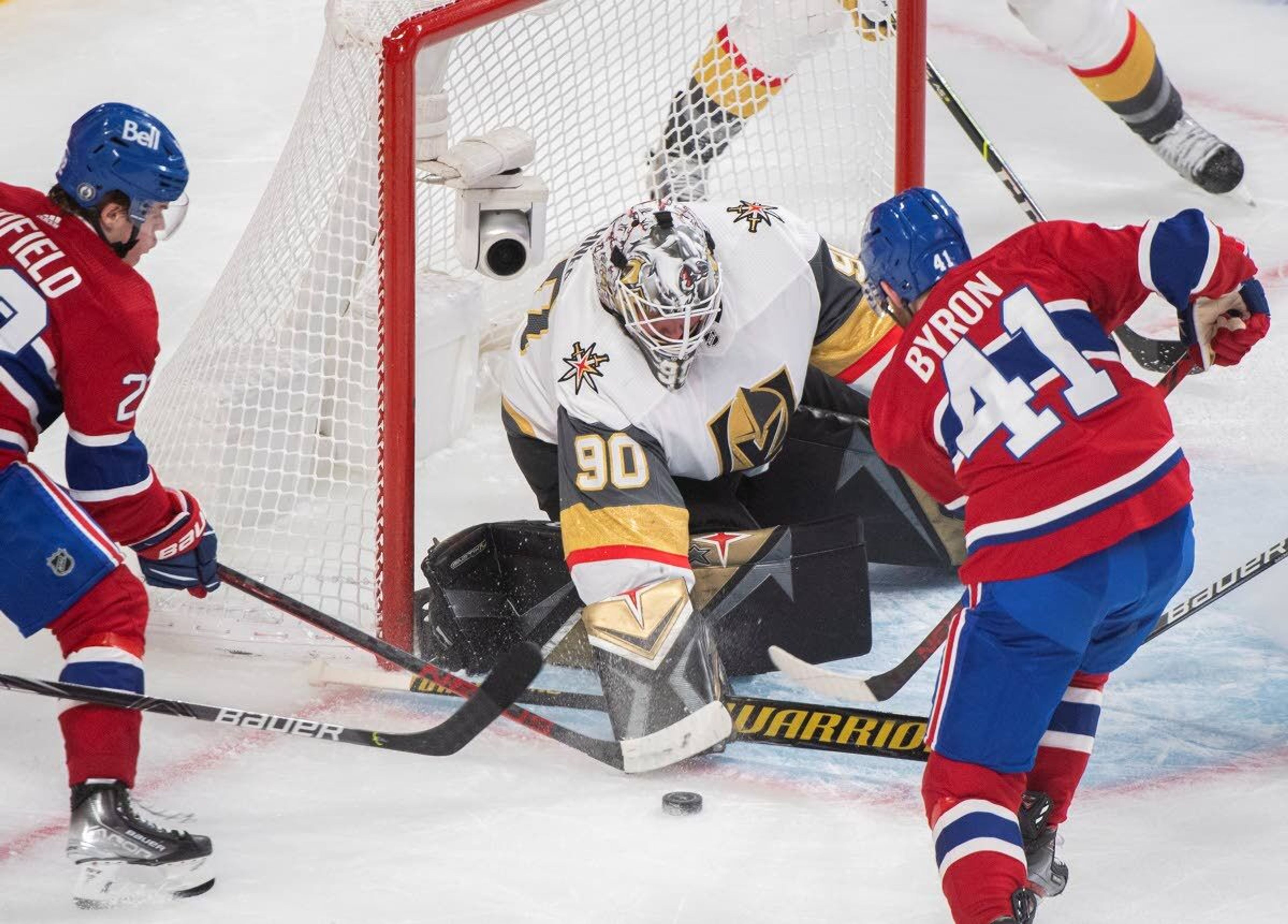 Montreal Canadiens' Paul Byron (41) and teammate Cole Caufiled (22) move in on Vegas Golden Knights goaltender Robin Lehner during the second period of Game 4 in an NHL Stanley Cup playoff hockey semifinal in Montreal, Sunday, June 20, 2021.