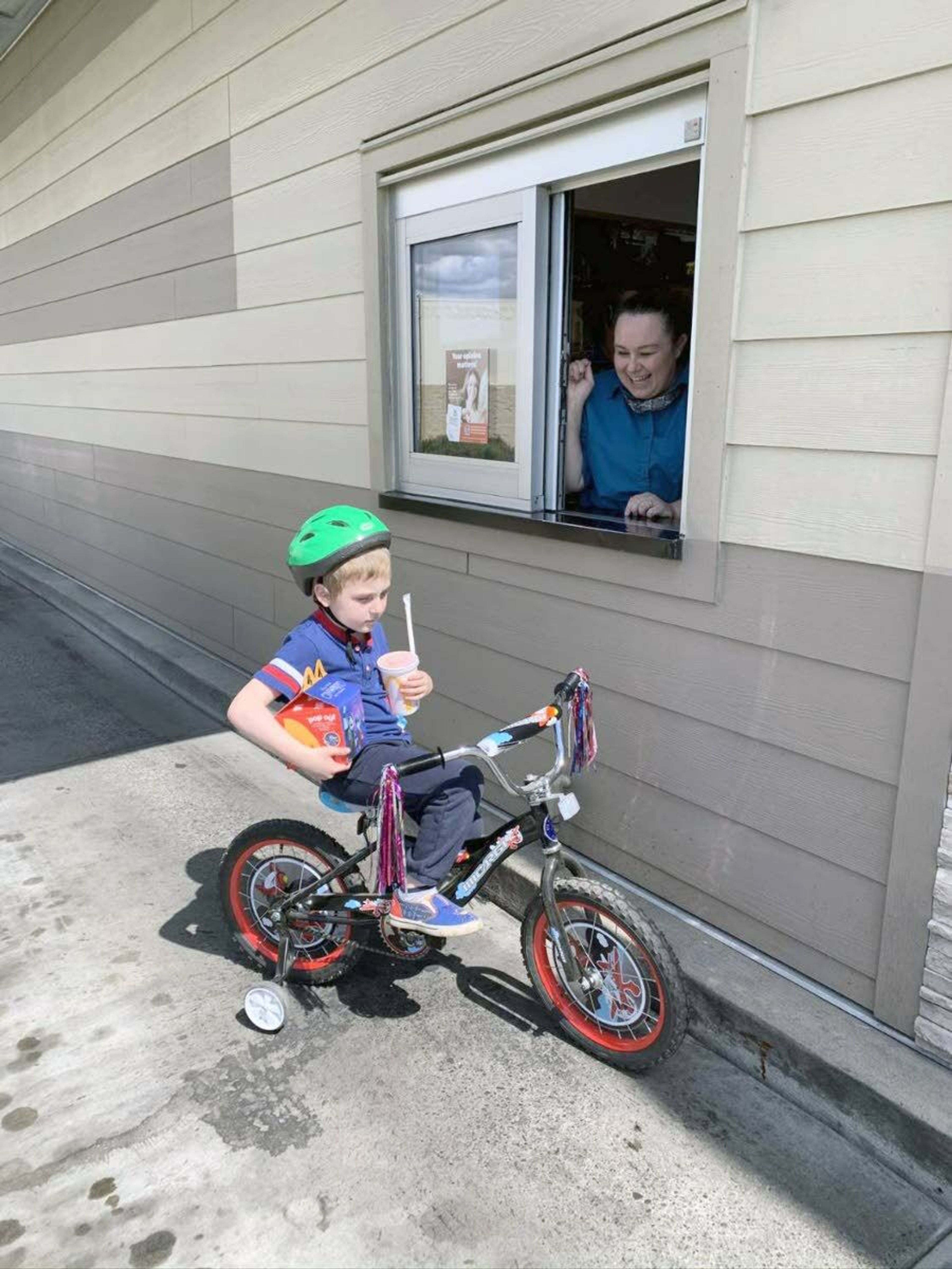 Jakoby Kershisnik gets his birthday lunch at the McDonald’s drive-through on his new bike after his party was canceled.