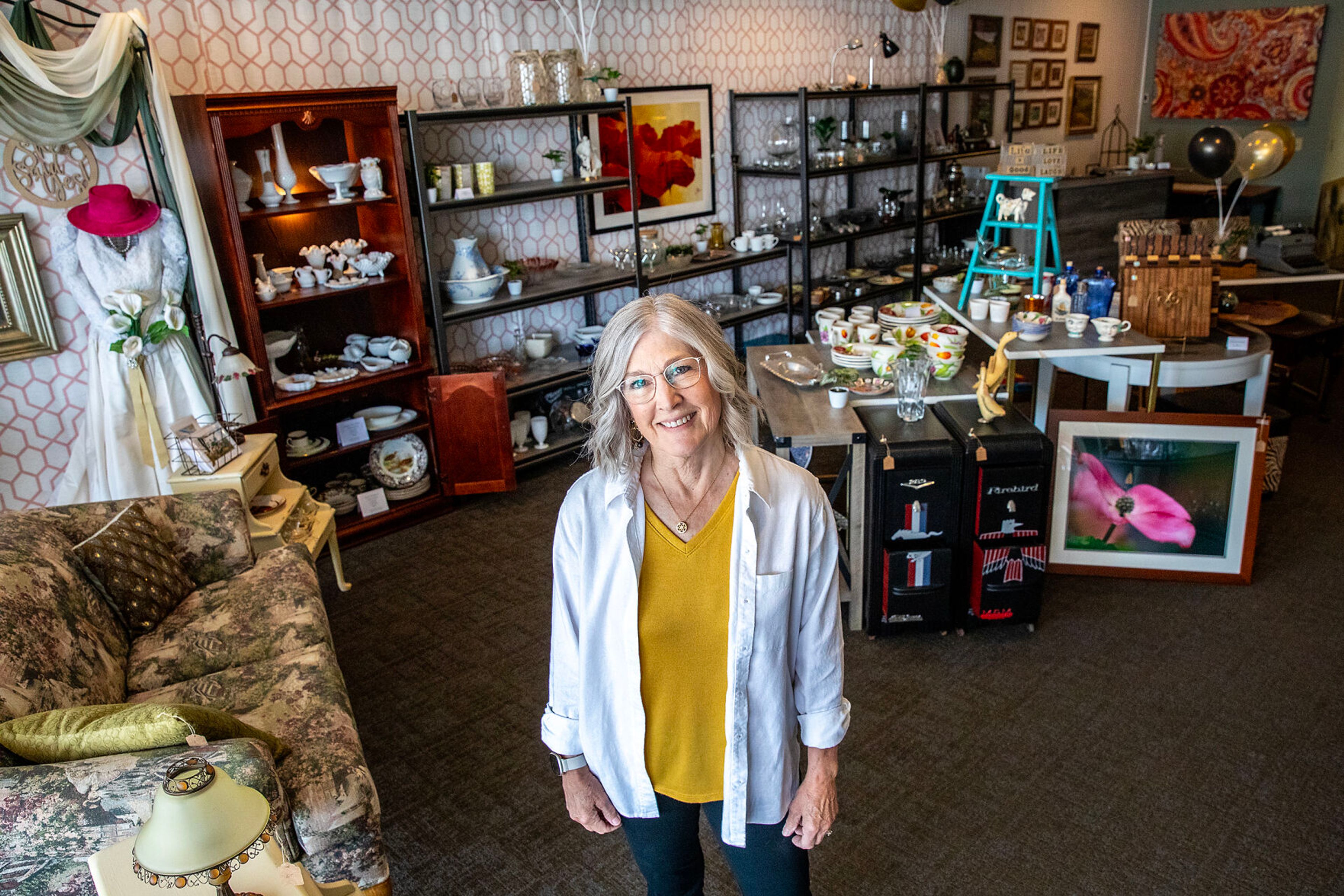 Shelia Wooley poses for a picture inside Upscale Resale Consignment Shop Tuesday in Clarkston.