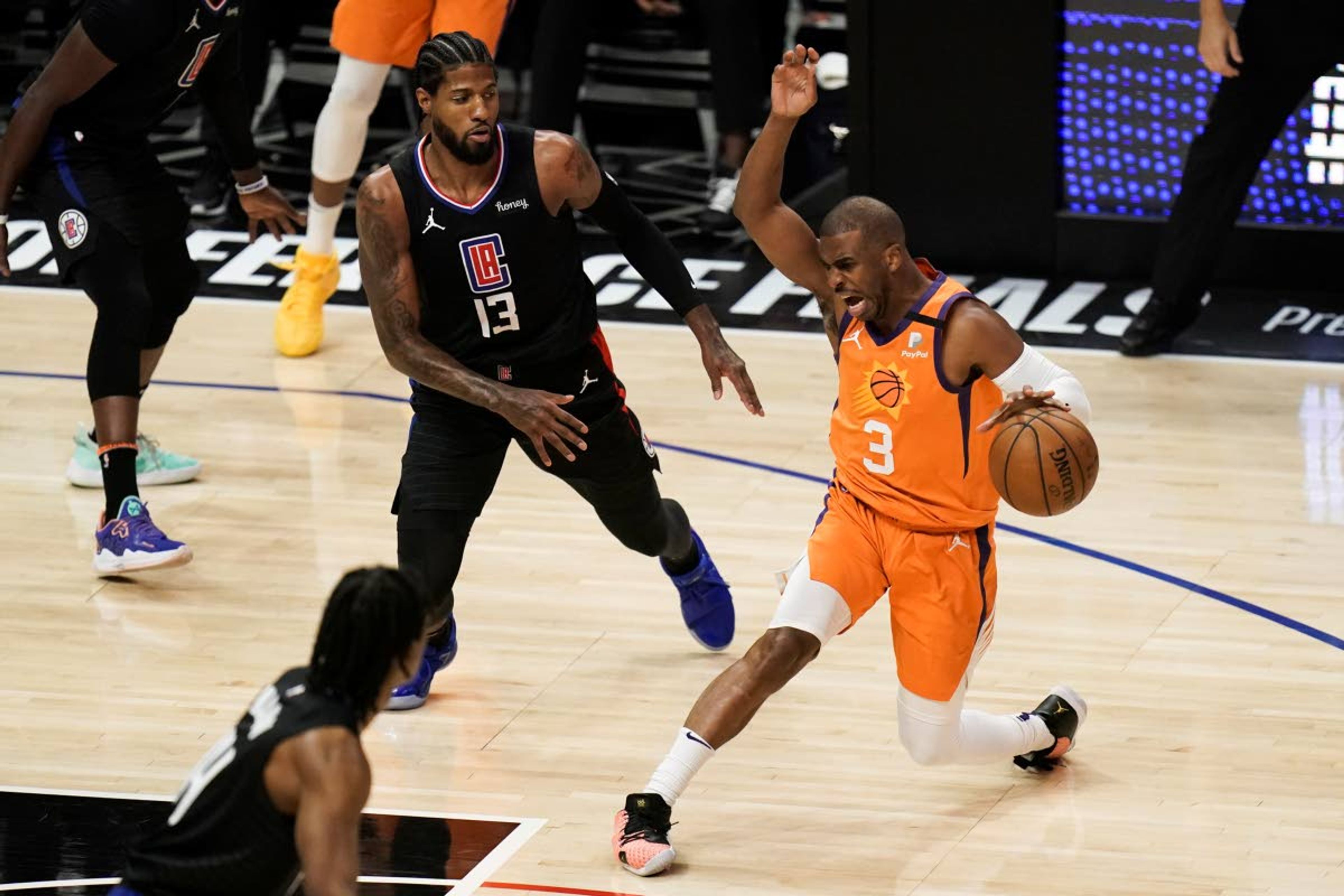 Phoenix Suns' Chris Paul, right, is pressured by Los Angeles Clippers' Paul George during the first half in Game 6 of the NBA basketball Western Conference finals, Wednesday, June 30, 2021, in Los Angeles. (AP Photo/Jae C. Hong)