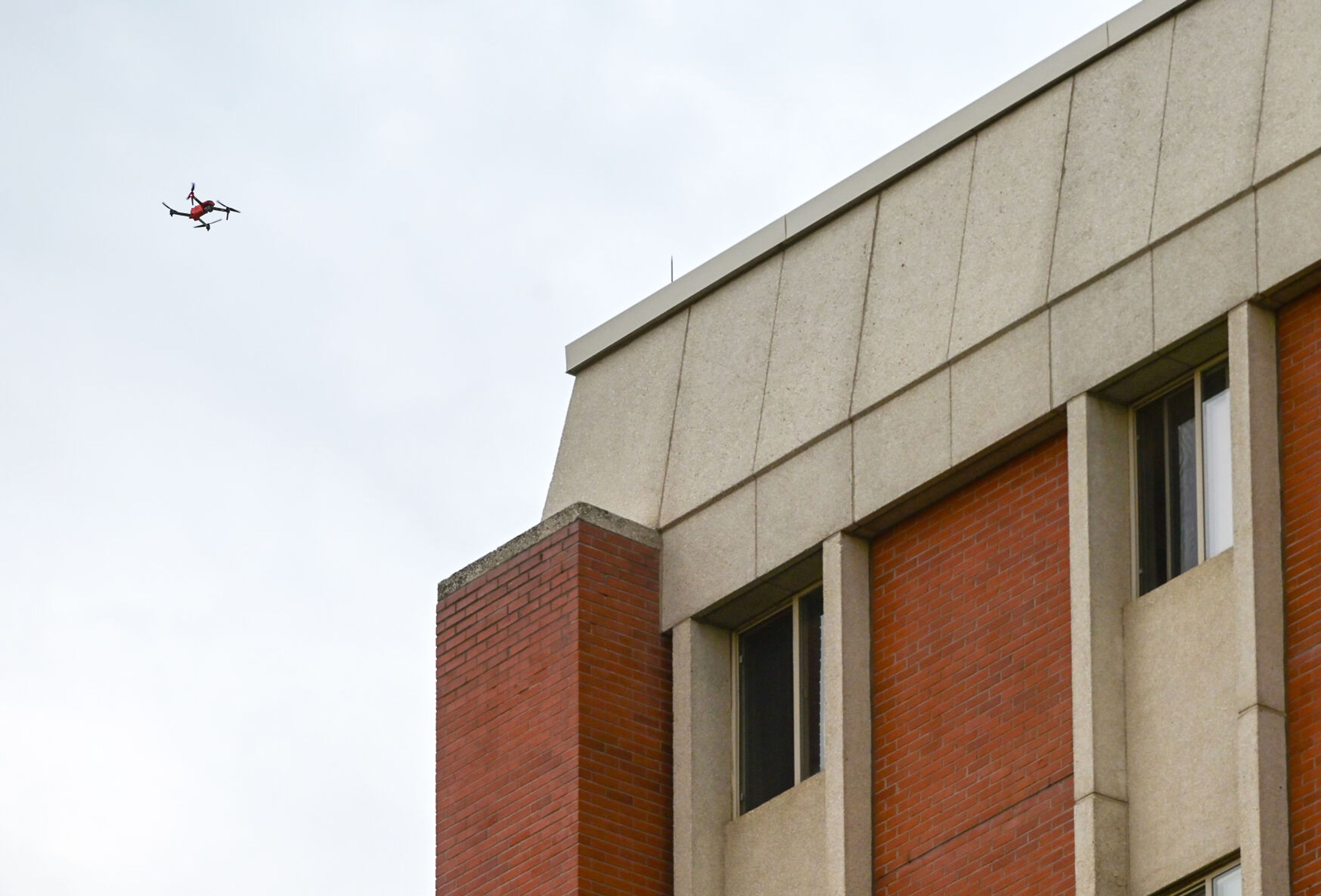 A drone flies around the Theophilus Tower after an inmate walked away from a cleaning crew Tuesday on the University of Idaho campus in Moscow.