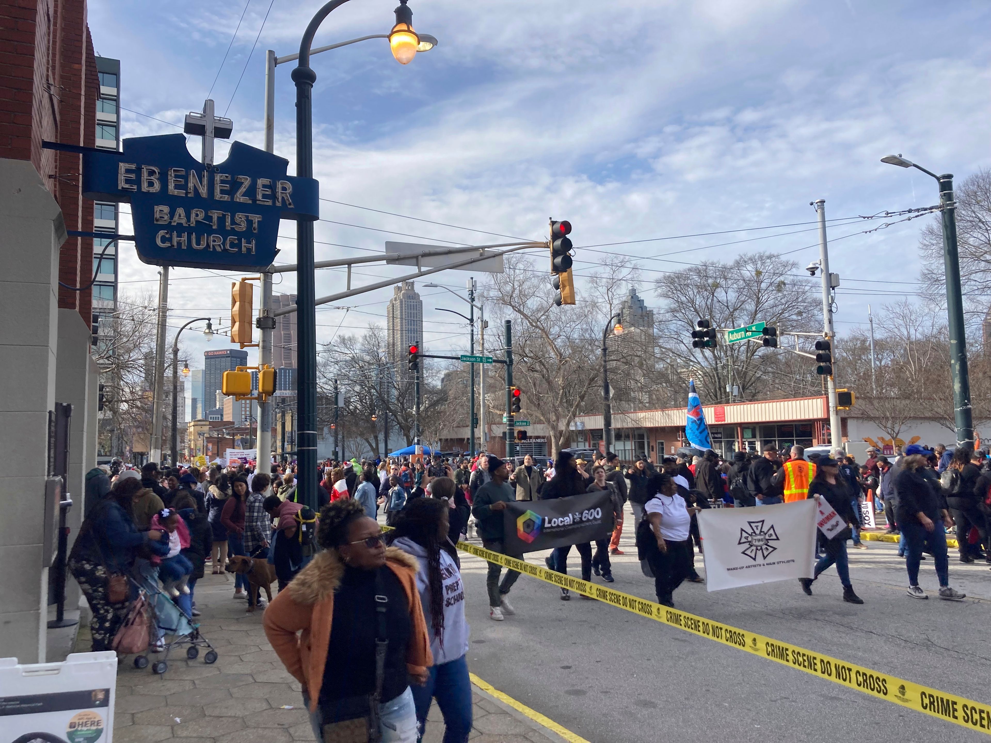 Union laborers, voting rights advocates and civil rights activists march down Auburn Avenue in Atlanta, Monday, Jan. 16, 2023, between the old Ebenezer Baptist Church where Martin Luther King Jr. once preached and the church's new campus. They marched as part of the 38th federal holiday observance honoring the slain civil rights leader. (AP Photo/Bill Barrow)