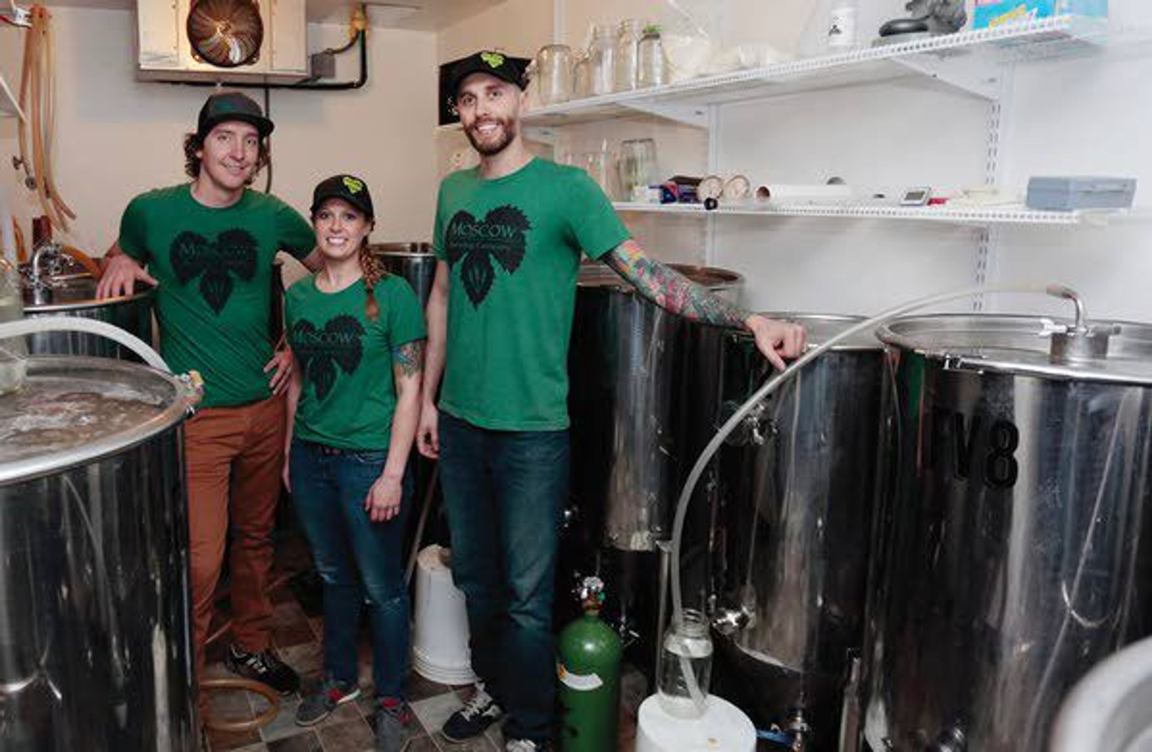 Moscow Brewery owners Aaron Hart, Leah Hart and And Severson pose in the fermentation room of the establishment Friday.