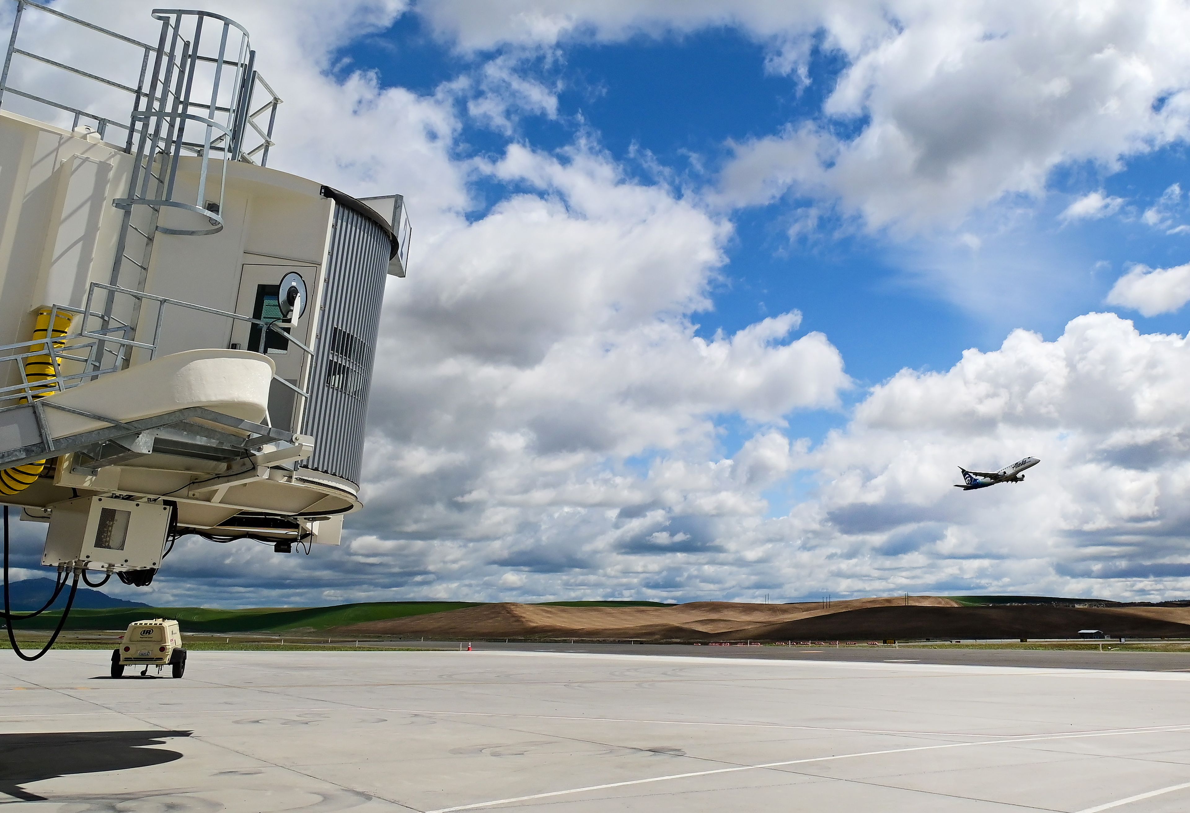 A flight with Alaska Airlines moves past the new terminal at the Pullman-Moscow Regional Airport as it takes off from the runway in Pullman on Tuesday.