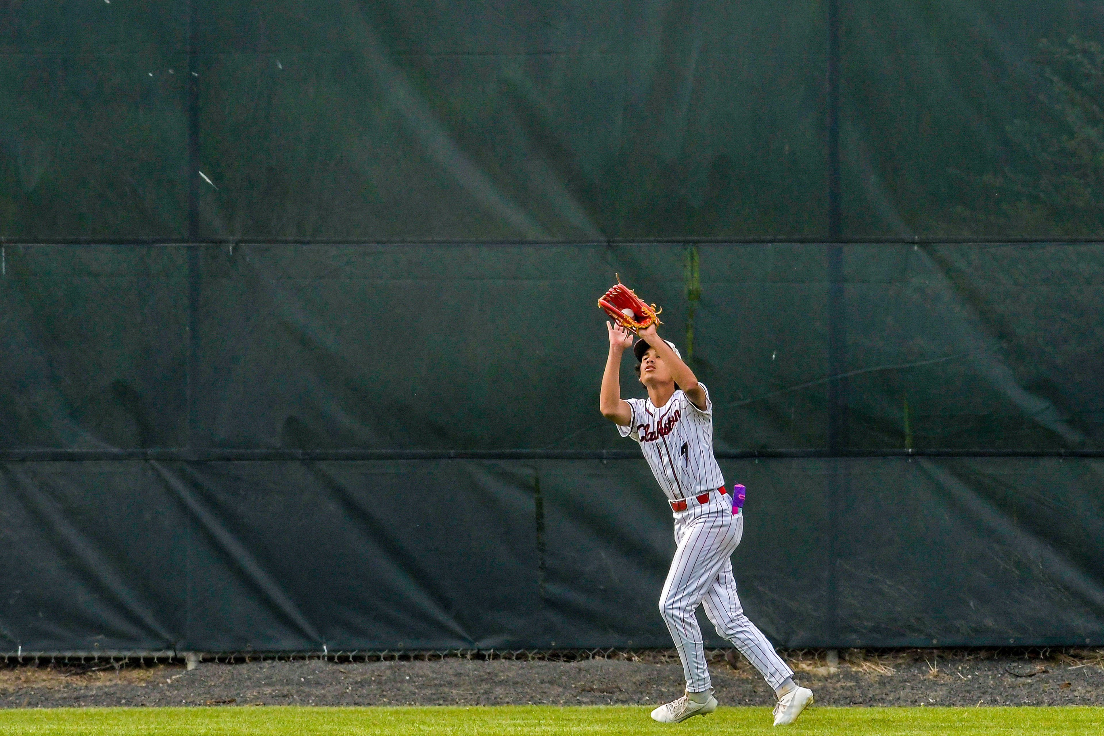 Clarkston center fielder Isaiah Woods makes a catch against Pullman during a semifinal game of the district tournament Thursday in Pullman.