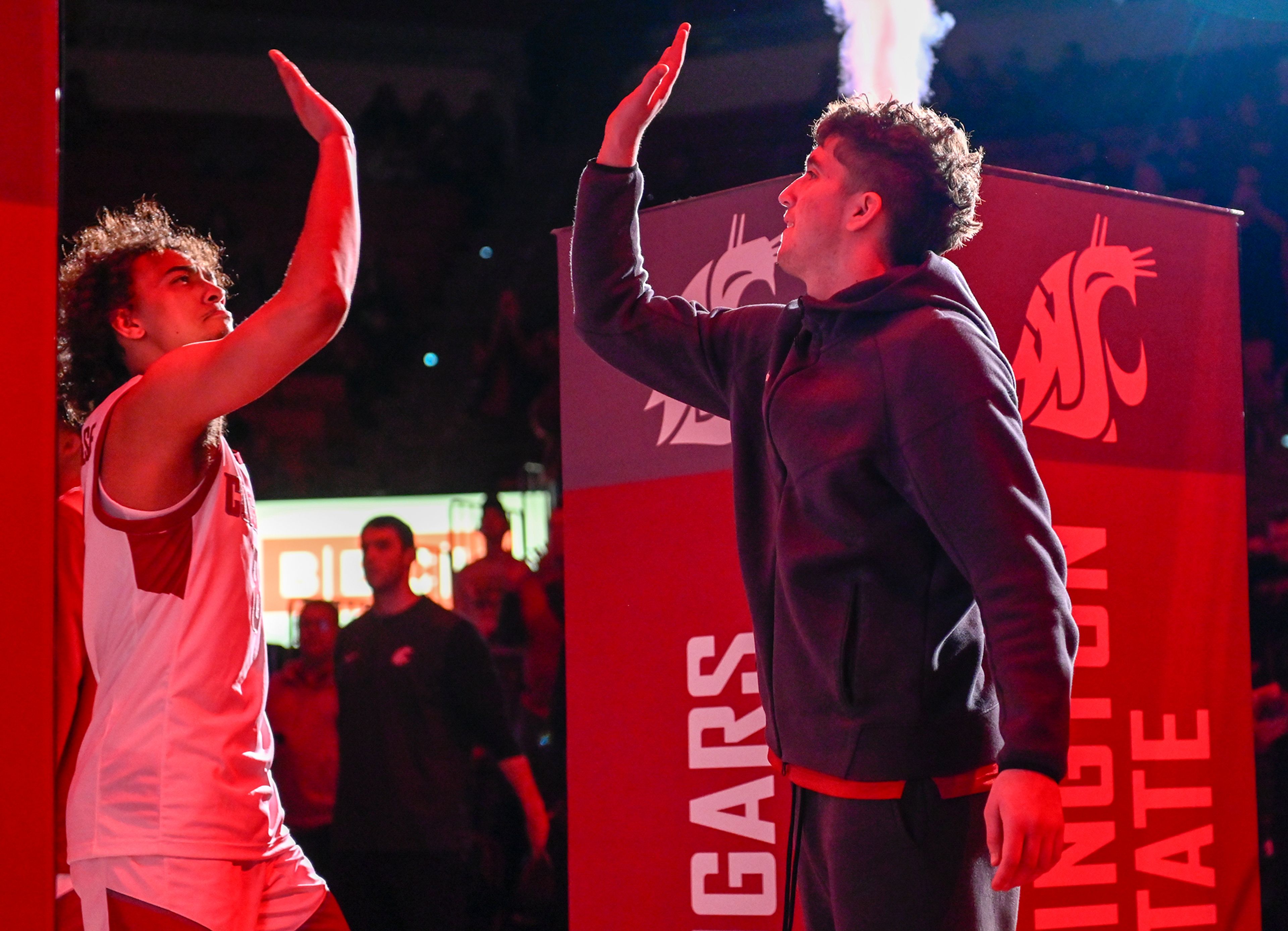 Washington State guard Nate Calmese high-fives Washington State guard Kase Wynott during player introductions Monday in Pullman before the Cougars took on Idaho in the Battle of the Palouse at Beasley Coliseum.