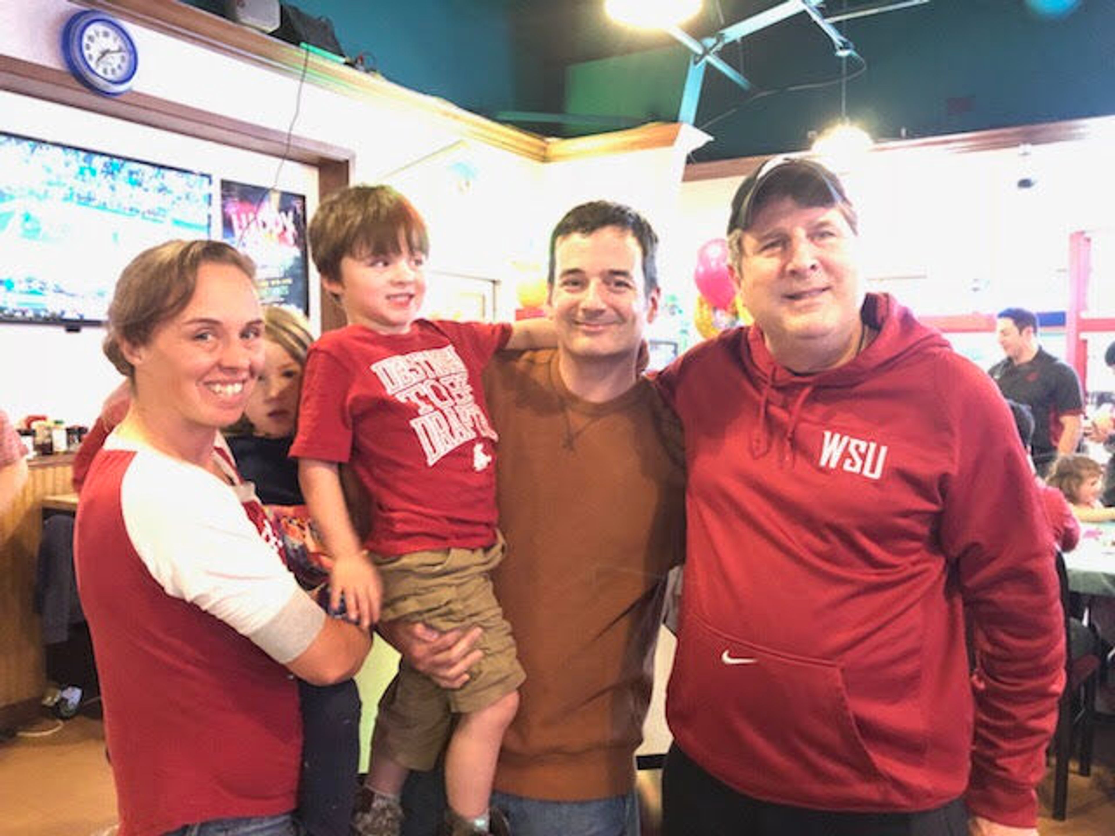 Former Washington State University football coach Mike Leach, right, poses with the Overstreet family (and a friend) at Zeppoz during the recording of Leach's weekly radio show back in 2017. Pictured left to right are Melissa Overstreet, Ava Aled (partially hidden), Daniel Overstreet, Jon Overstreet and Leach. Here's what Jon Oversteet remembers about the encounter: "My son (Daniel) asked Coach Leach what he should pick in the game rock, paper, scissors and Coach Leach responded, 'Dan, alway pick the rock.'" Leach, who coached eight season at WSU, died Dec. 12.