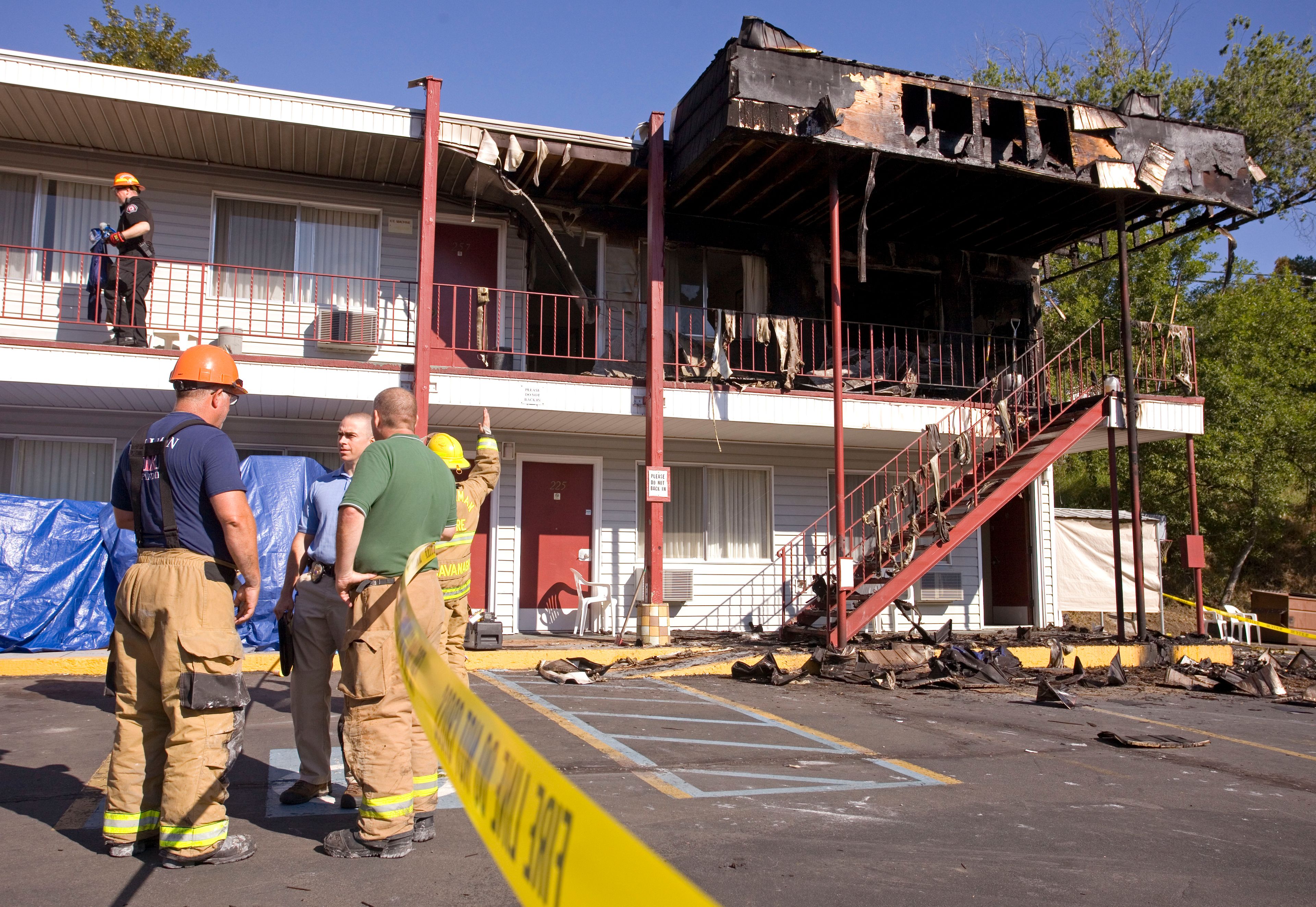 Investigators from the Pullman Fire Department and Washington State University Police Department work to determine the cause of a fire at the American Travel Inn on Tuesday on south Grand Avenue in Pullman.