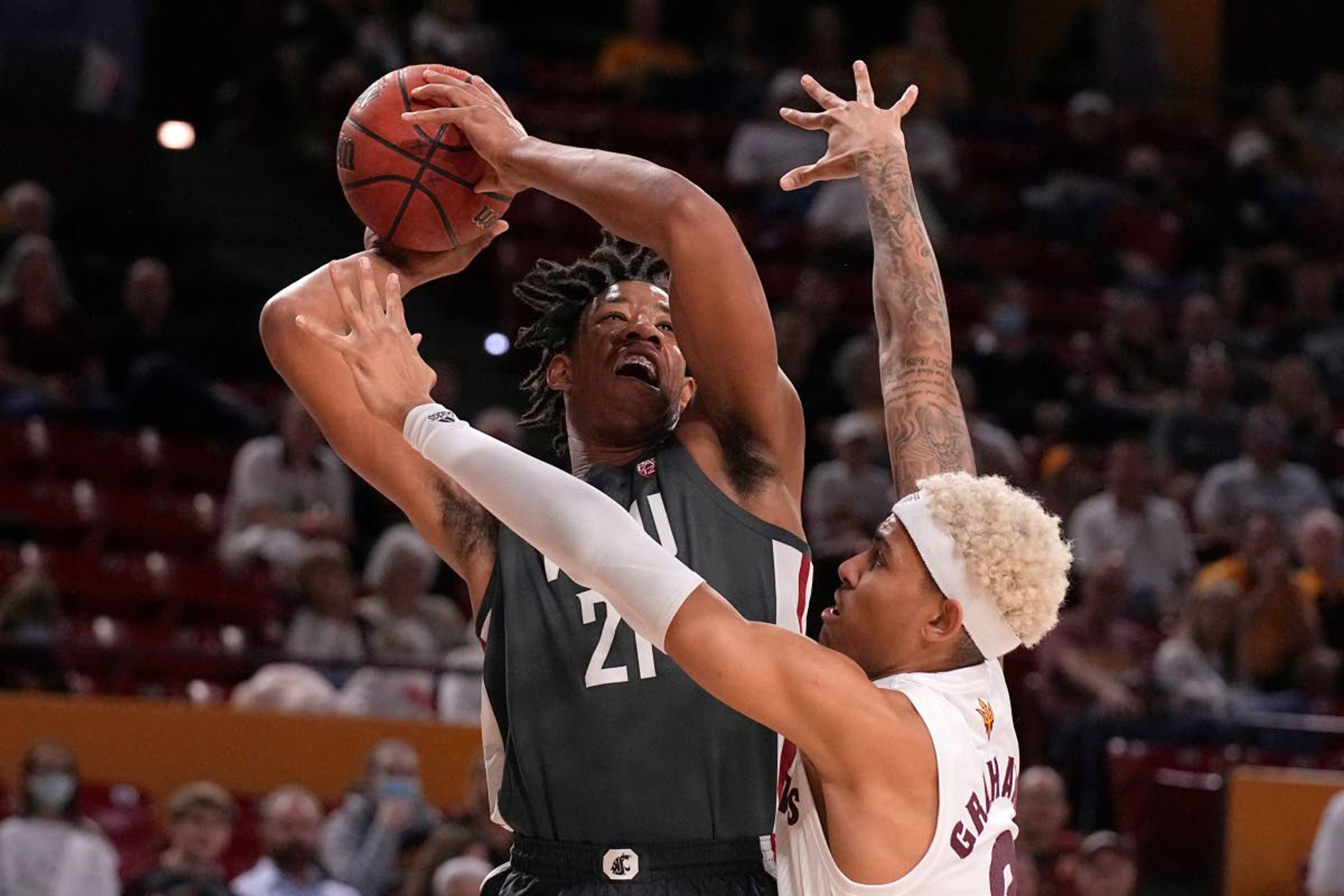 Washington State center Dishon Jackson shoots over Arizona State forward Jalen Graham (2) during the first half of an NCAA college basketball game Wednesday, Dec. 1, 2021, in Tempe, Ariz. (AP Photo/Rick Scuteri)