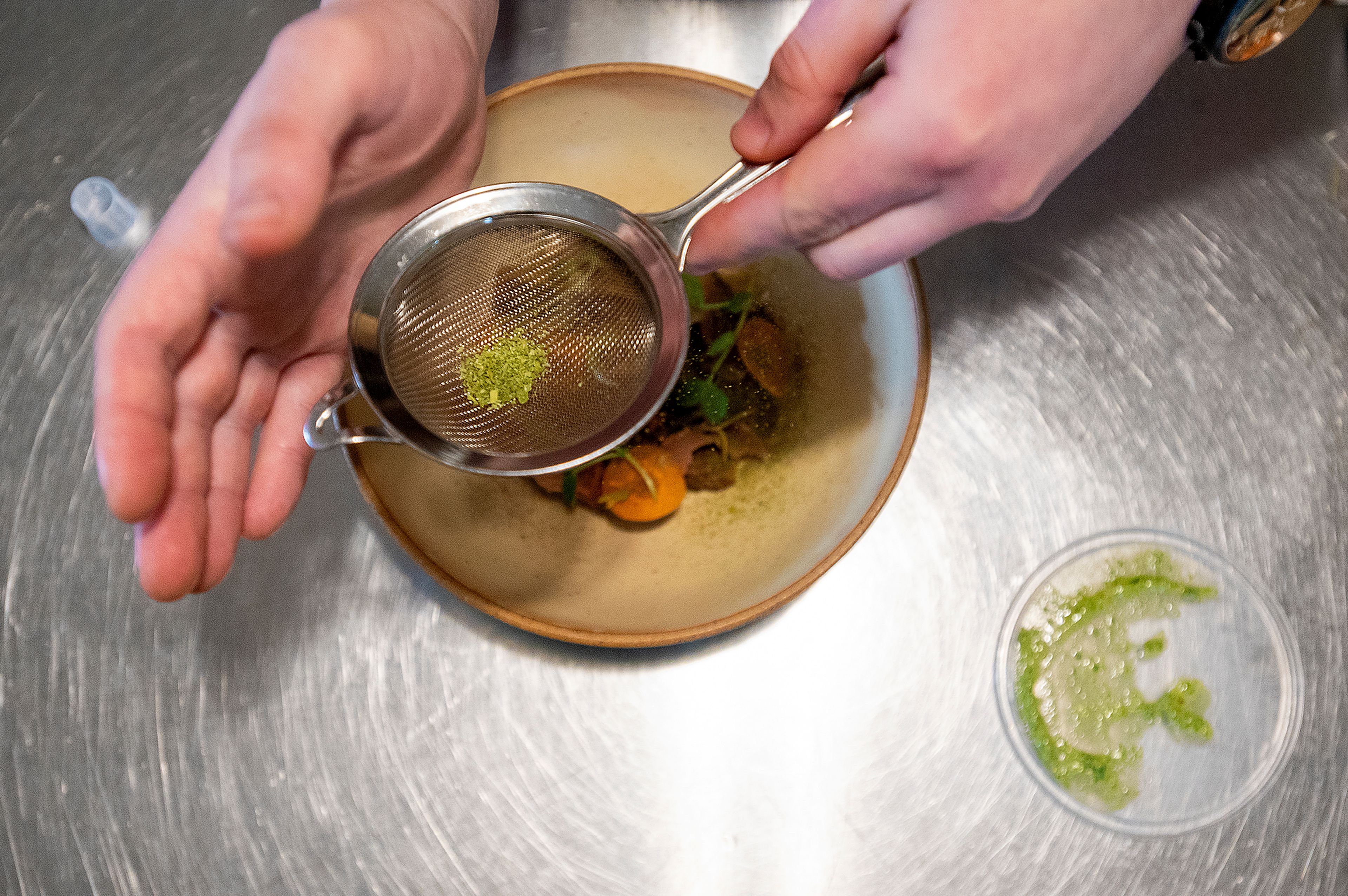 Pecoraro garnishes the dish with a powder of hand-picked spring herbs, including woodruff, green onion and wild chive.