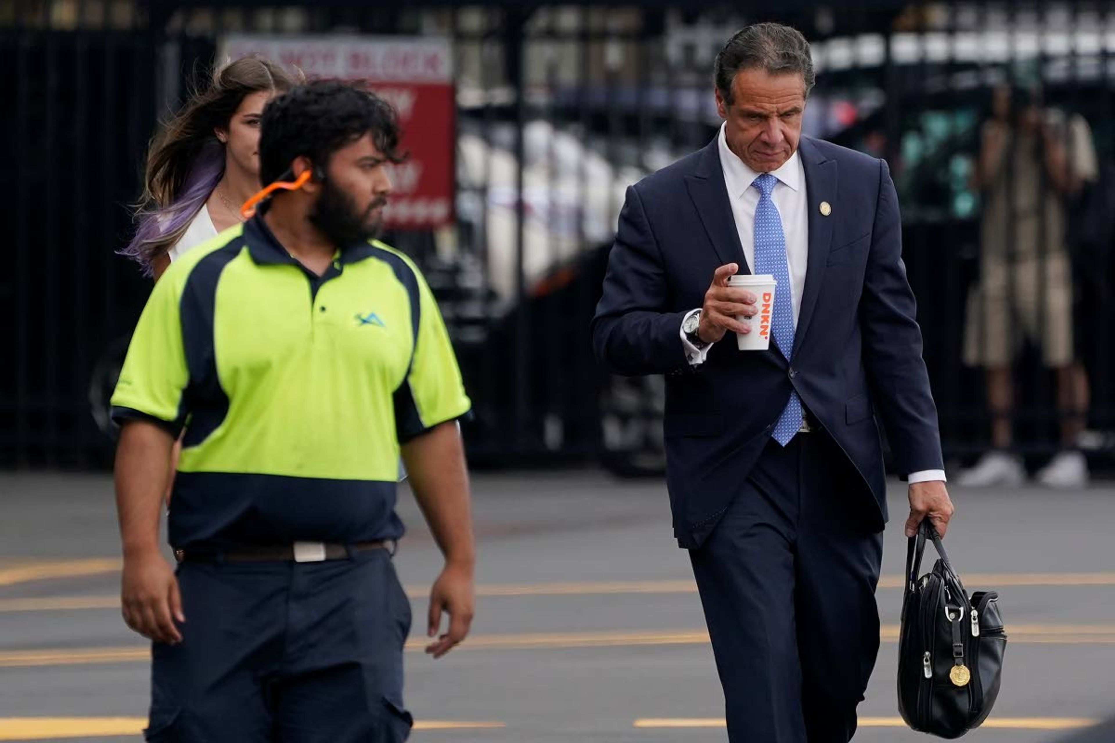 New York Gov. Andrew Cuomo, right, prepares to board a helicopter after announcing his resignation, Tuesday, Aug. 10, 2021, in New York. Cuomo says he will resign over a barrage of sexual harassment allegations. The three-term Democratic governor's decision, which will take effect in two weeks, was announced Tuesday as momentum built in the Legislature to remove him by impeachment. (AP Photo/Seth Wenig)