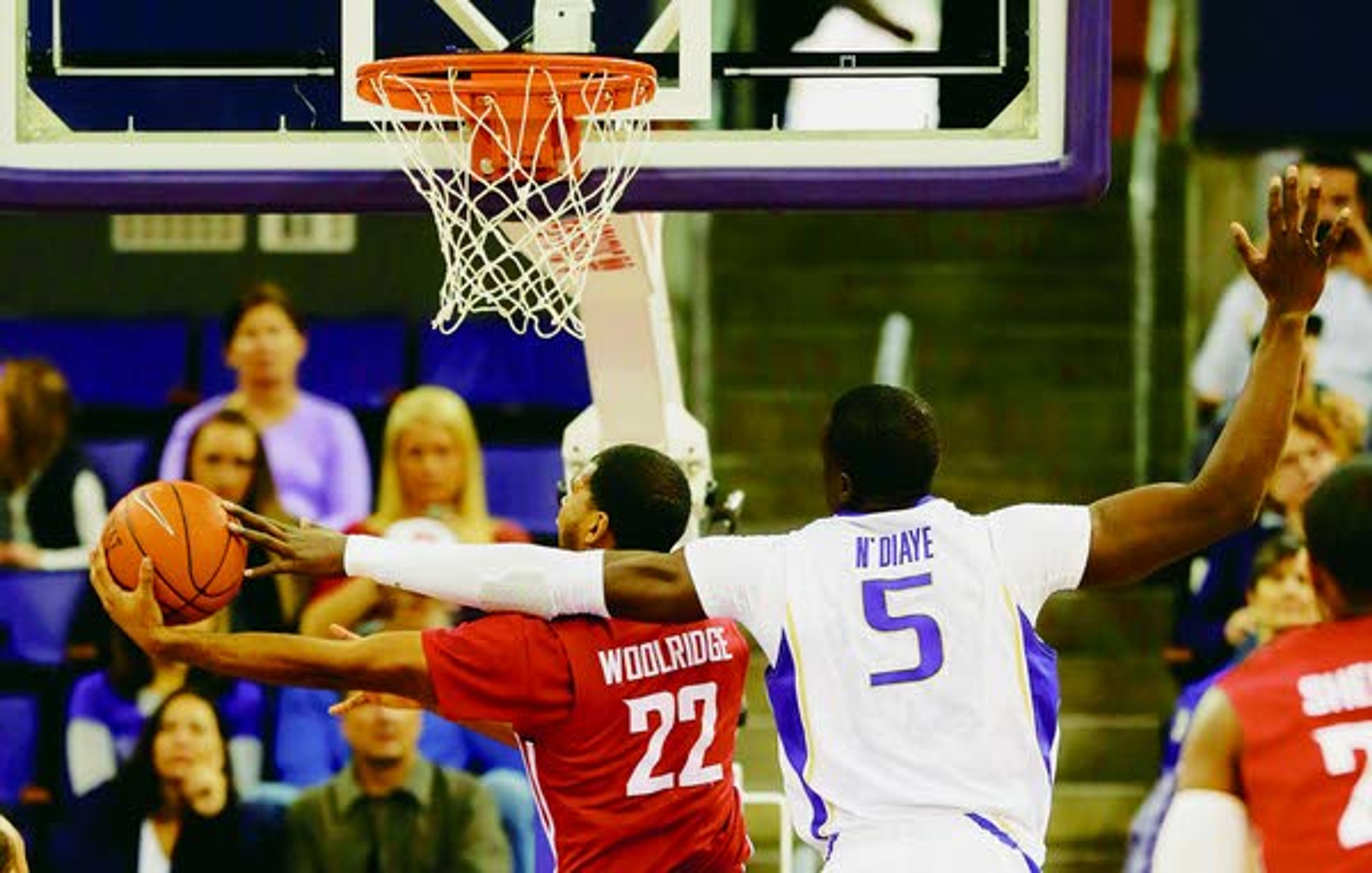 Washington’s Aziz N'Diaye (5) tries to block a shot by Washington State’s Royce Woolridge (22) in the first half of Sunday’s in Seattle.