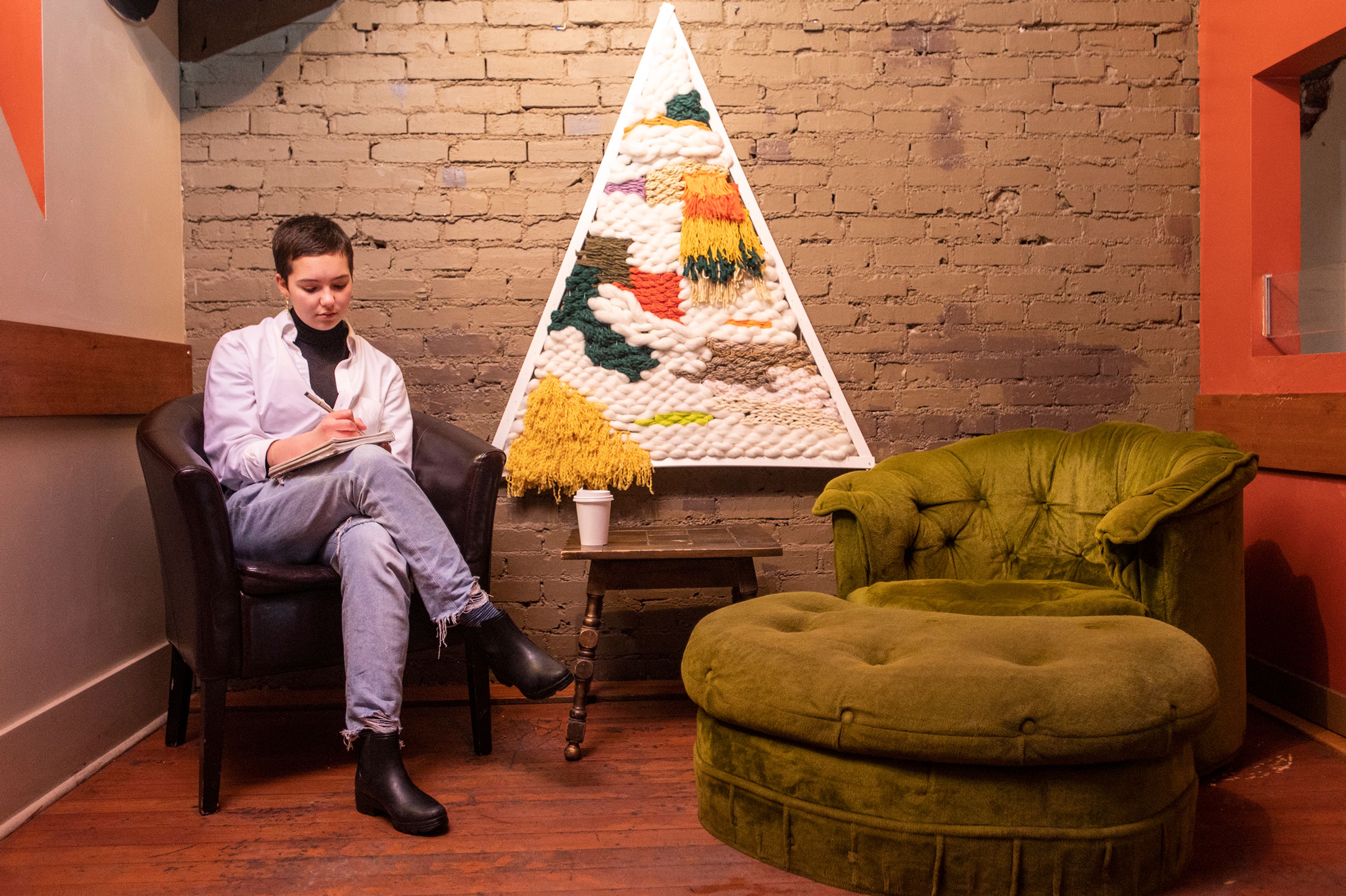 Eleanor Pimentel, of Moscow, relaxes inside One World Cafe in Moscow in January. Pimentel, then a senior at Moscow High School, earned national recognition for her digital art portfolio.