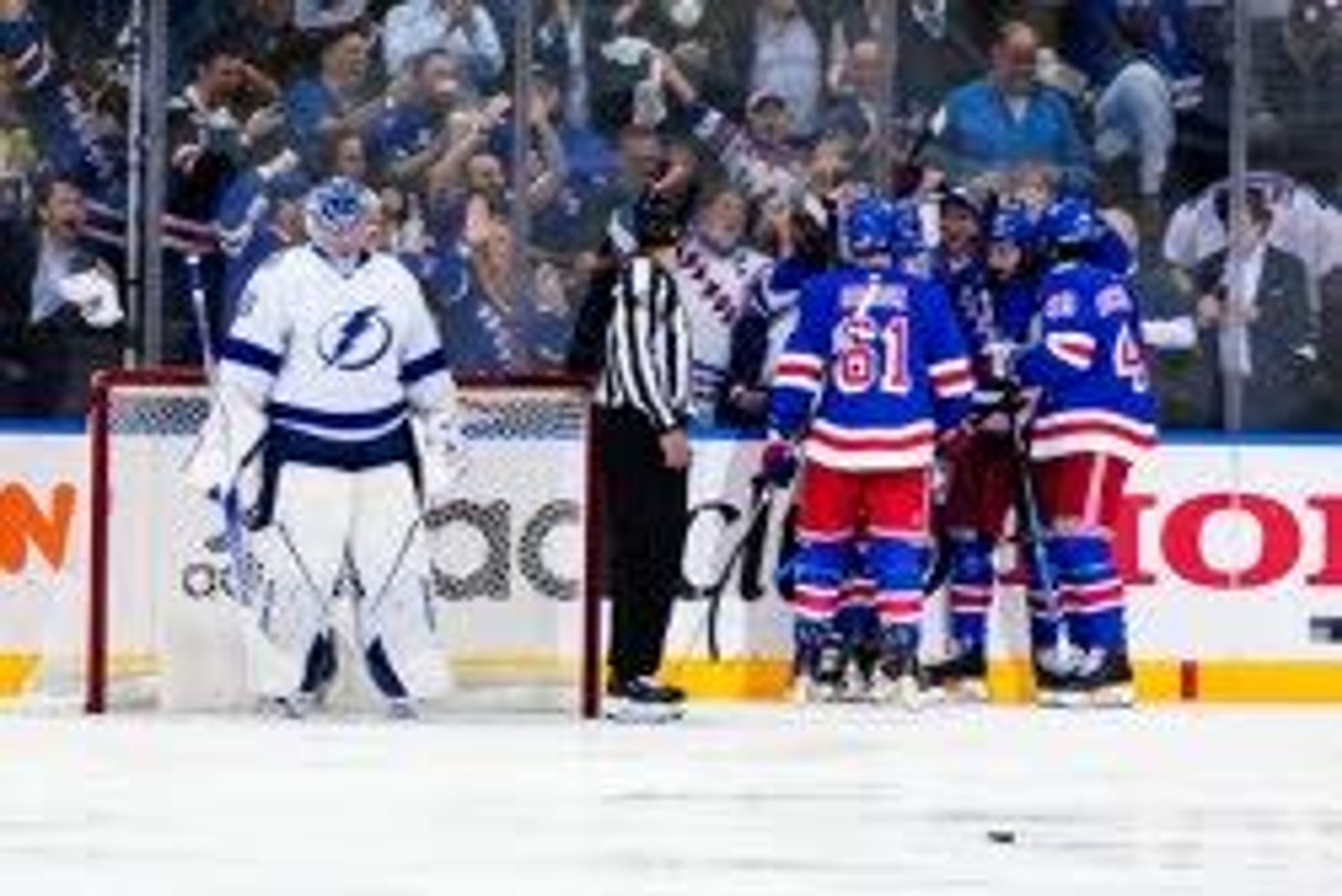 Tampa Bay Lightning goaltender Andrei Vasilevskiy, left, looks down as the New York Rangers celebrate a goal by Chris Kreider during the first period in Game 1 of the NHL hockey Stanley Cup playoffs Eastern Conference finals Wednesday, June 1, 2022, in New York. (AP Photo/Frank Franklin II)