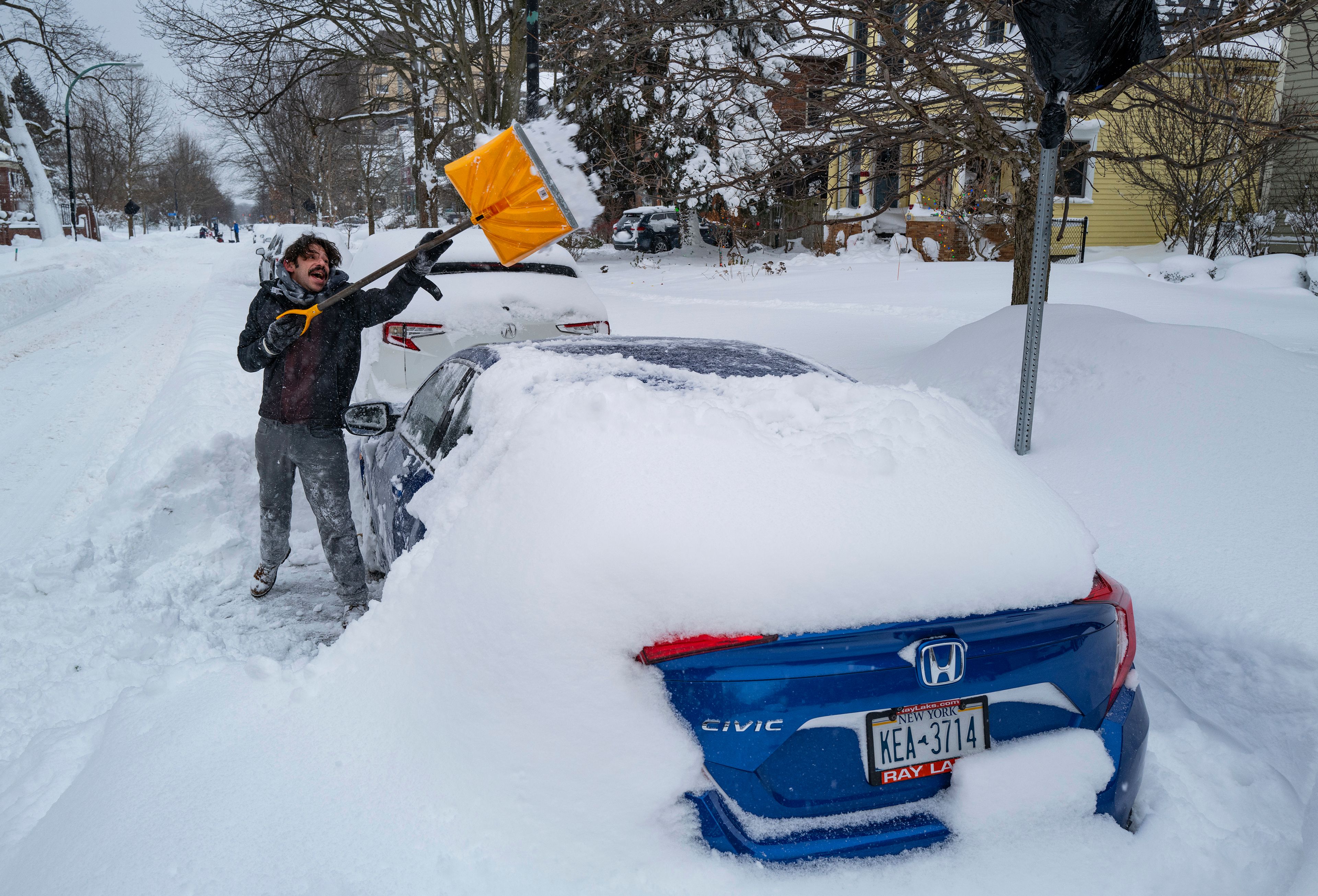 Christian Parker of Buffalo, N.Y., shovels out his car in the Elmwood Village neighborhood of Buffalo, N.Y. Monday, Dec. 26, 2022, after a massive snow storm blanketed the city. Along with drifts and travel bans, many streets were impassible due to abandoned vehicles. (AP Photo/Craig Ruttle)