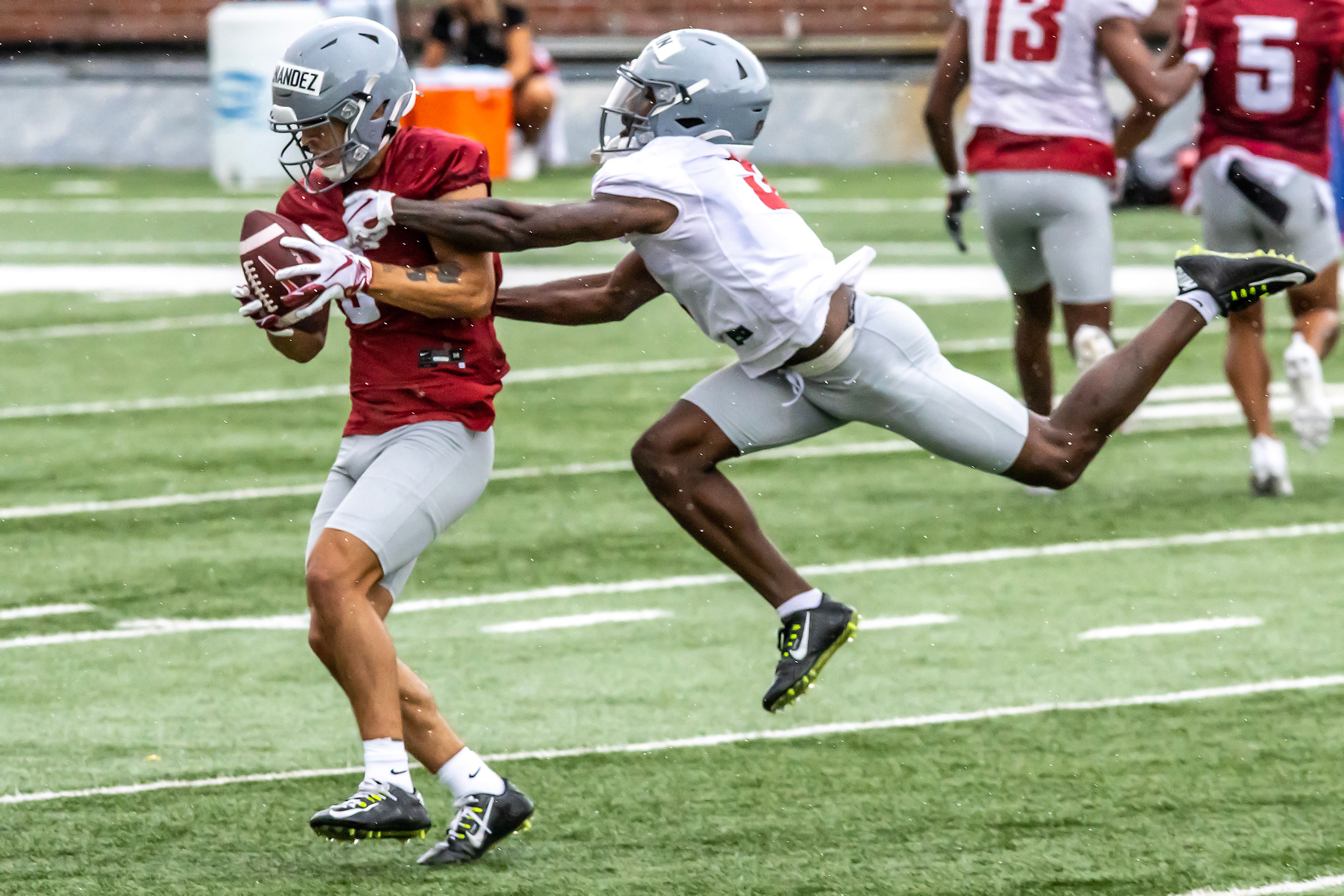 Wide receiver Carlos Hernandez makes a catch under pressure from defensive back Cam Lampkin during practice Wednesday at Gesa Field in Pullman.