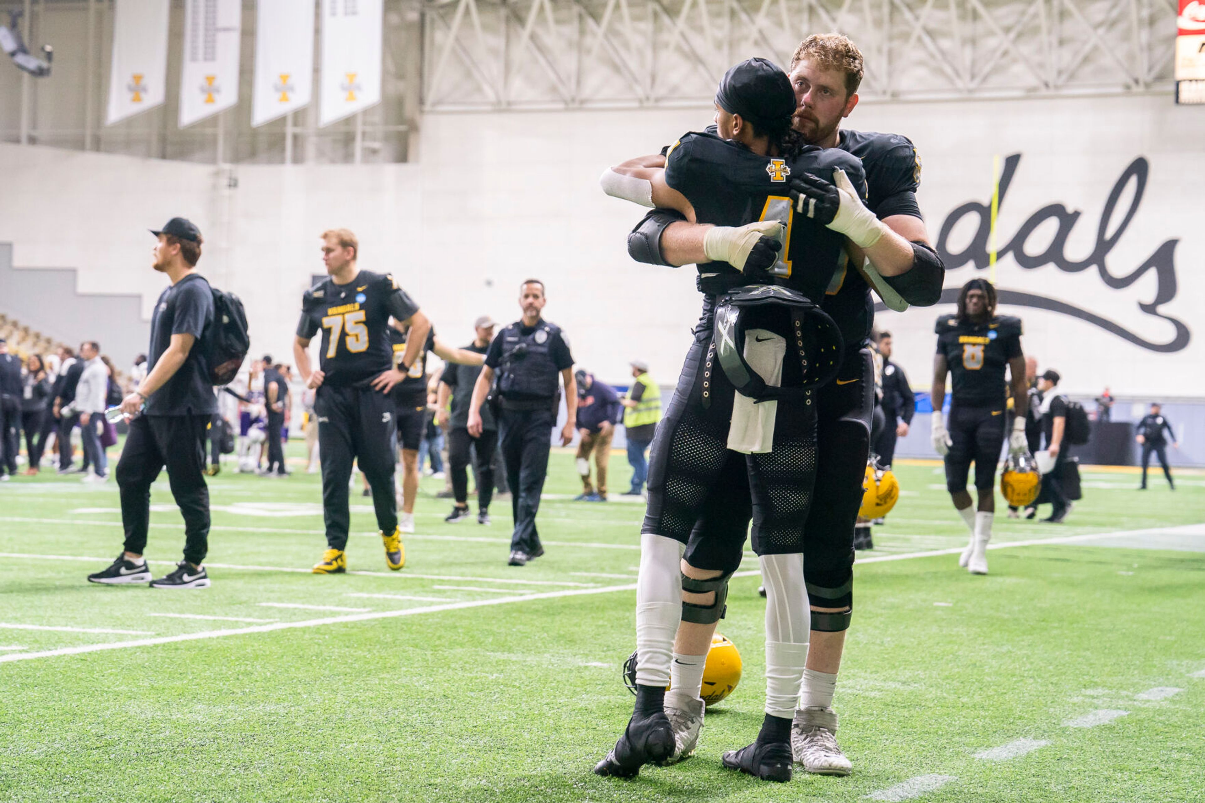 Vandals quarterback Gevani McCoy (4) hugs a teammate after losing a game against Albany in the FCS playoff quarterfinals Saturday at the P1FCU Kibbie Dome in Moscow.