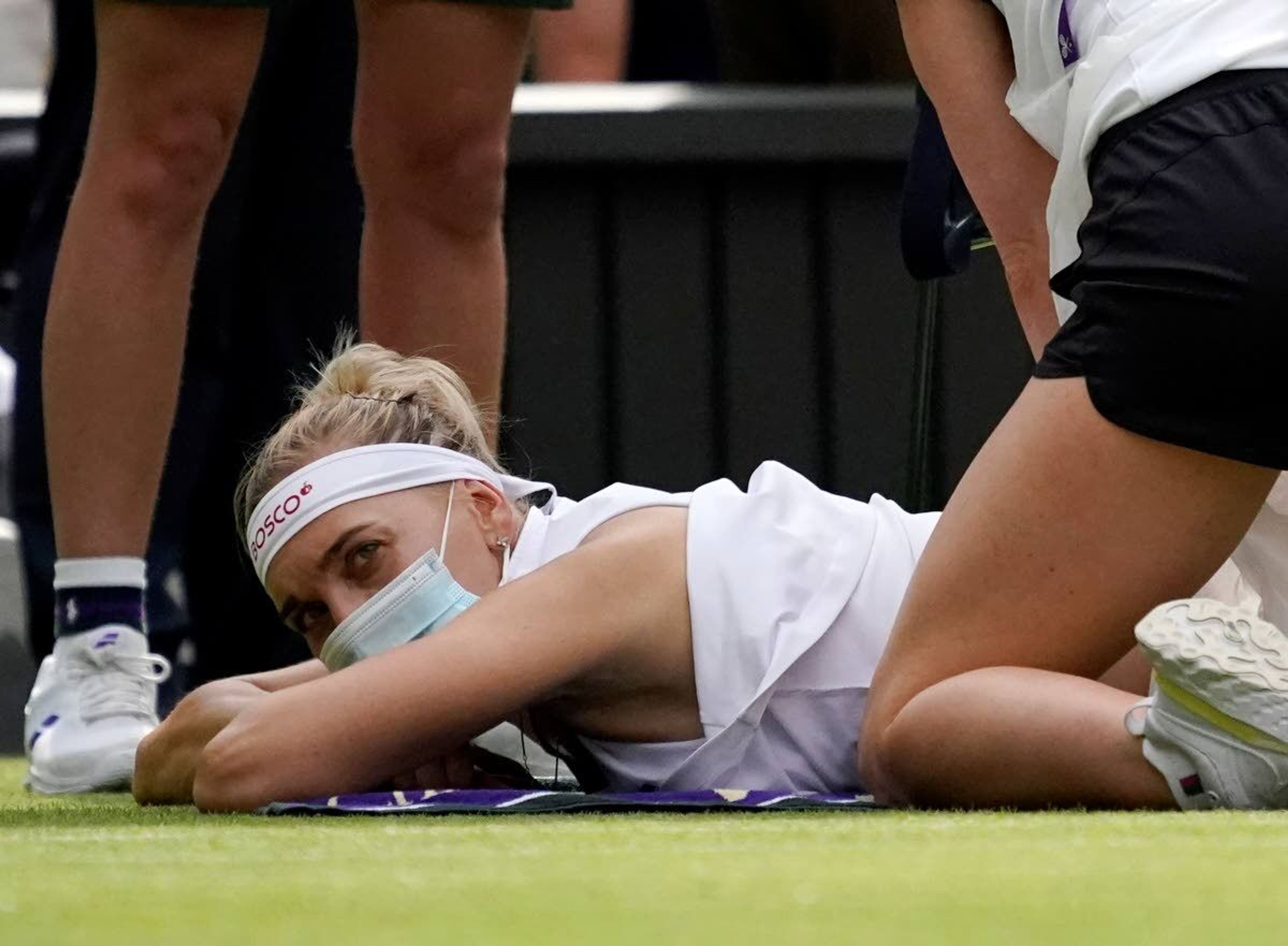 Russia's Elena Vesnina is seen by a physiotherapist on court during the women's singles second round match against Coco Gauff of the US on day four of the Wimbledon Tennis Championships in London, Thursday July 1, 2021. (AP Photo/Alberto Pezzali)