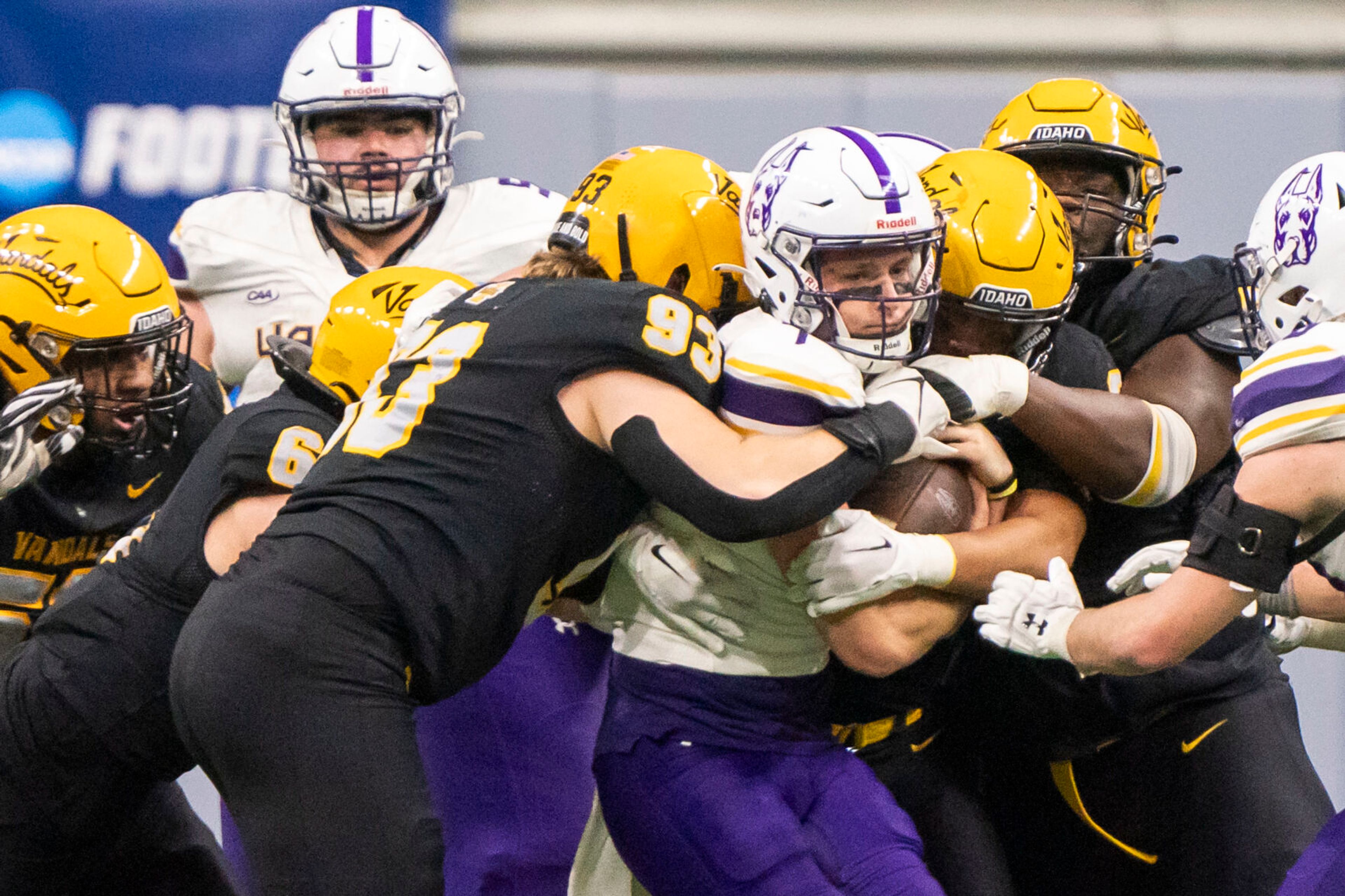 Idaho defenders grab ahold of Albany Great Danes quarterback Reese Poffenbarger, center, during a Football Championship Subdivision playoffs game on Dec. 9, 2023, in Moscow.