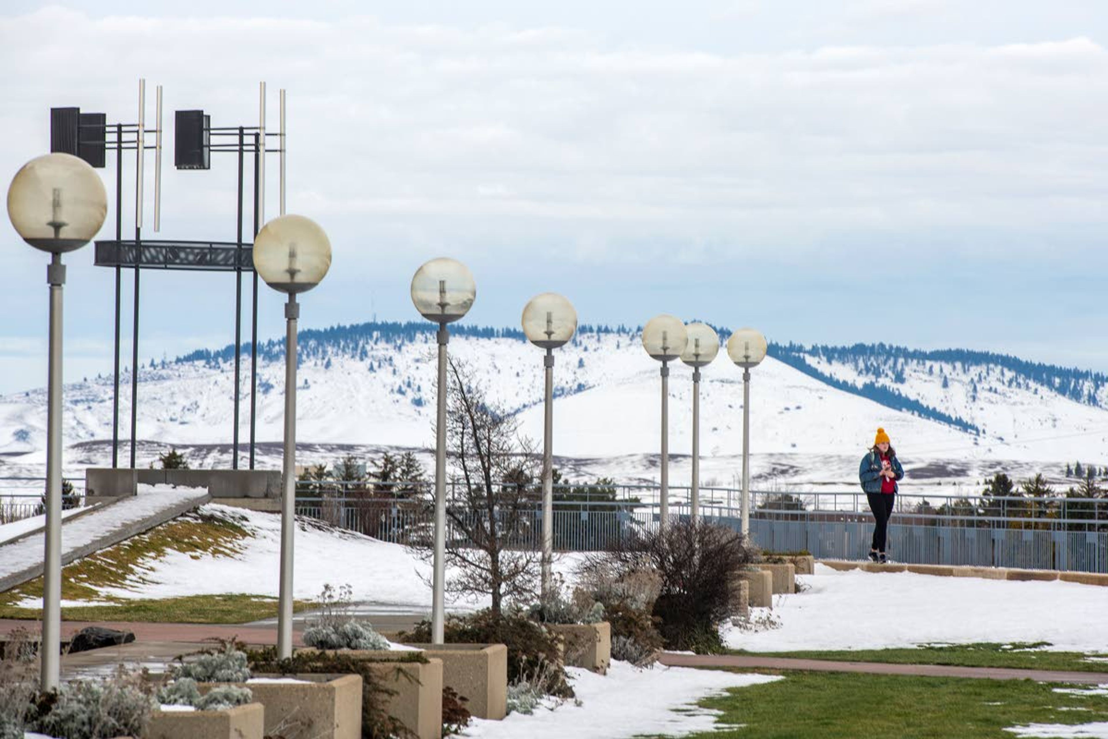 Jennie Connelie enjoys a break between classes Wednesday on the first day of spring semester as she walks on top of the Terrell Library on Washington State University’s campus in Pullman.