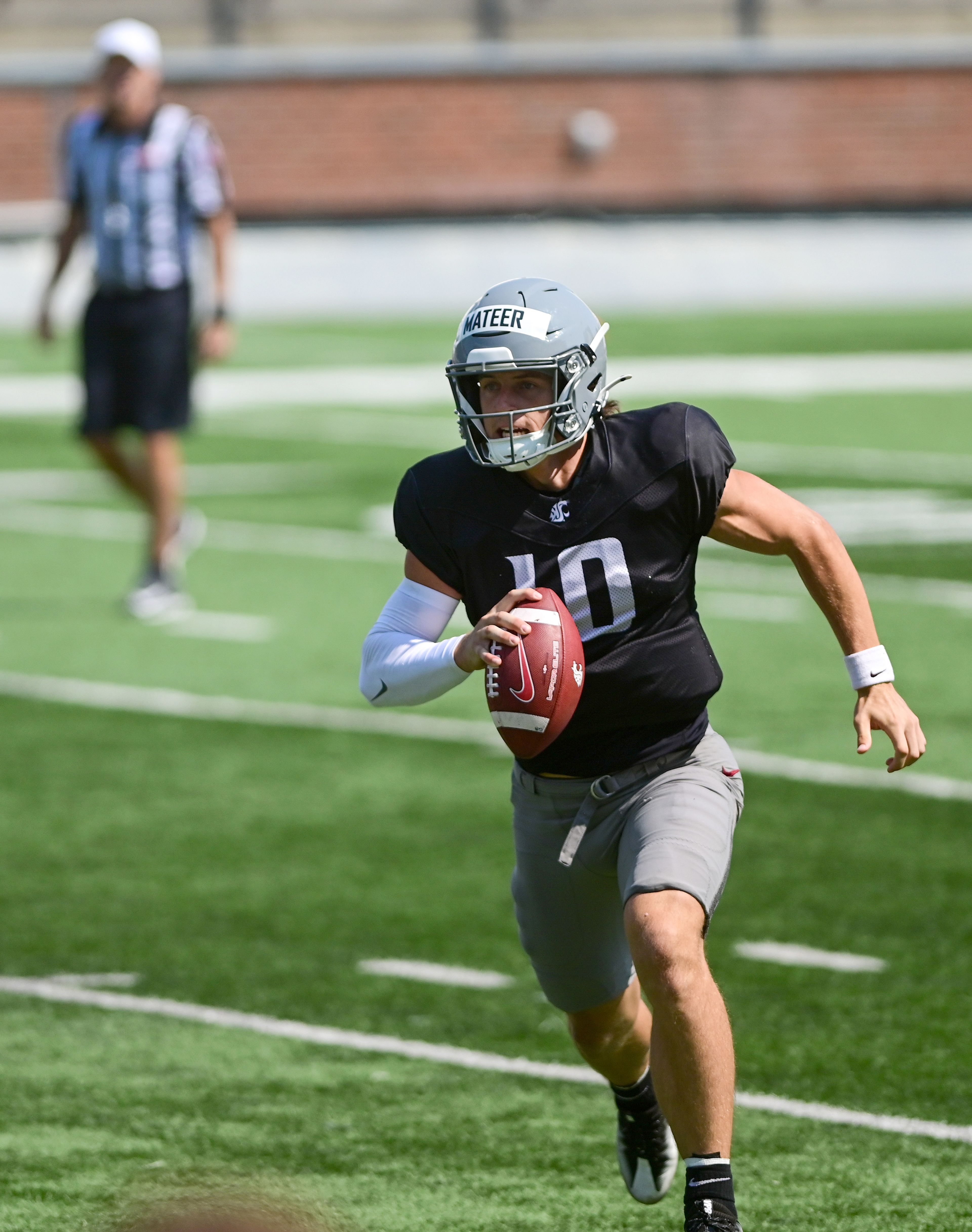 Washington State quarterback John Mateer runs with the ball during a fall practice scrimmage on Saturday in Pullman.