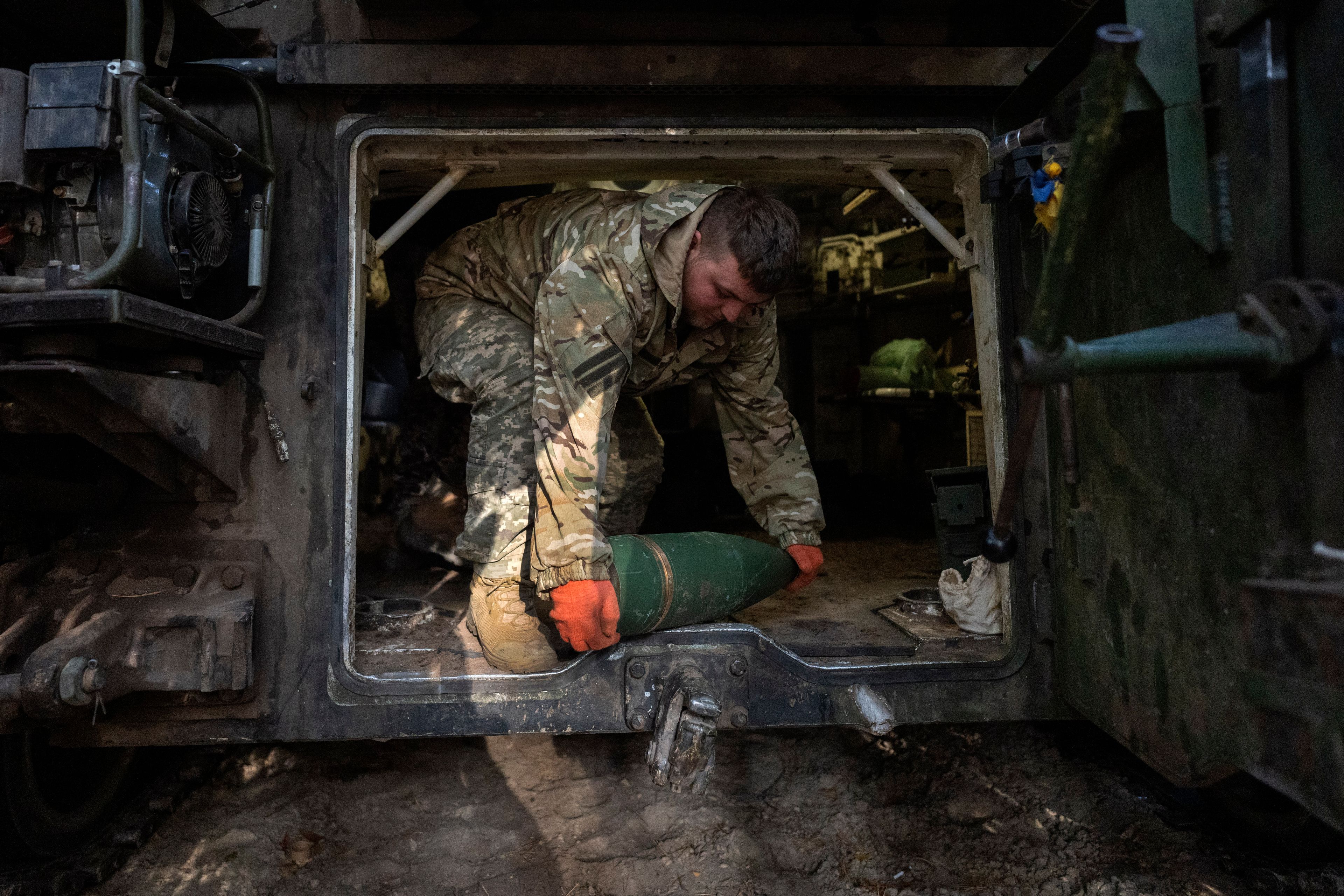 A Ukrainian soldier of the 92nd separate assault brigade prepares to fire a 155mm M-109 "Paladin" howitzer towards the Russian positions on the frontline near Vovchansk, Kharkiv region, Ukraine, Monday, Oct. 28, 2024. (AP Photo/Efrem Lukatsky)