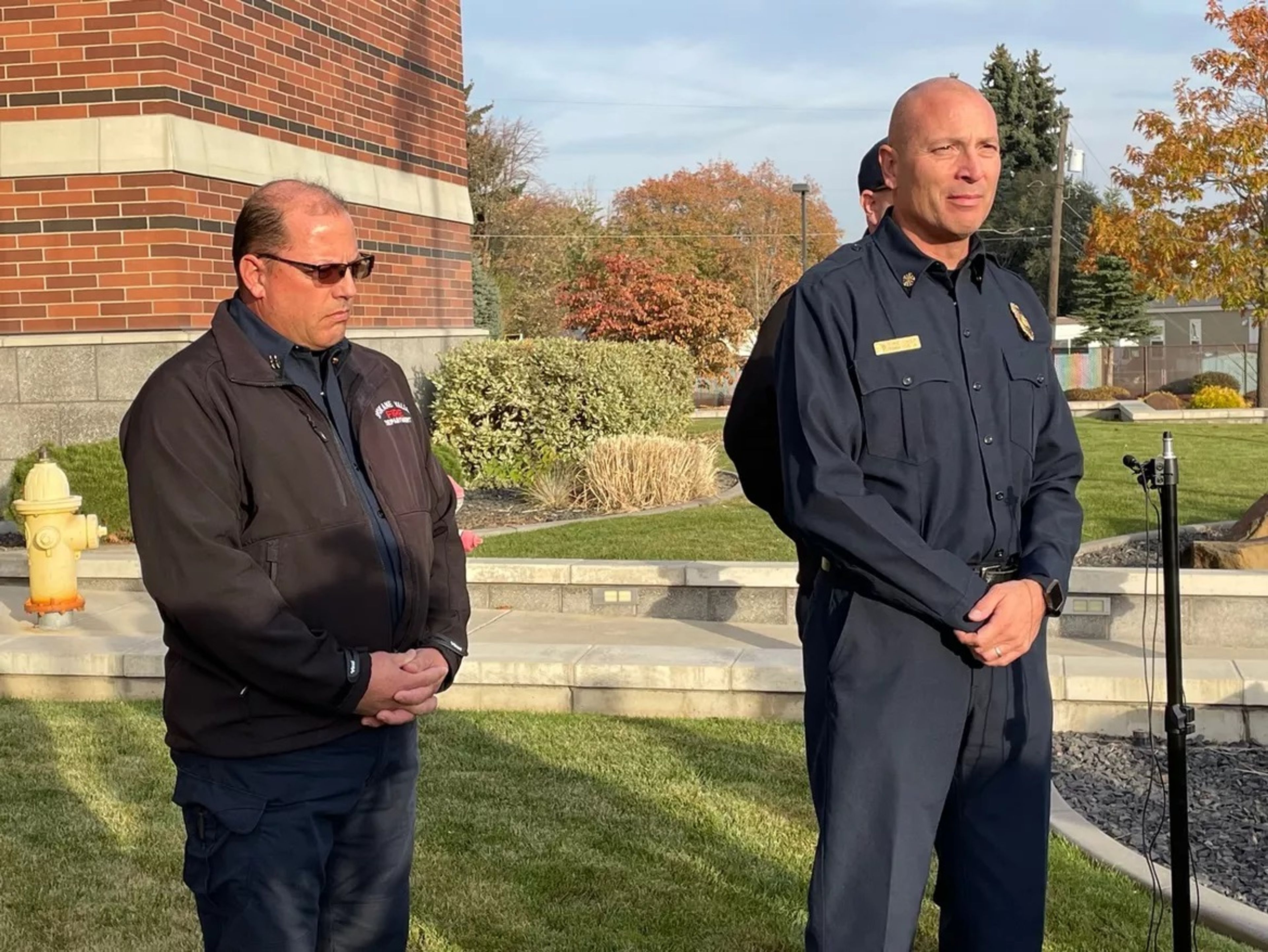 Spokane Valley Fire Department Chief Frank Soto Jr., right, speaks with reporters Tuesday outside the department’s headquarters about a Millwood house fire that killed two children.