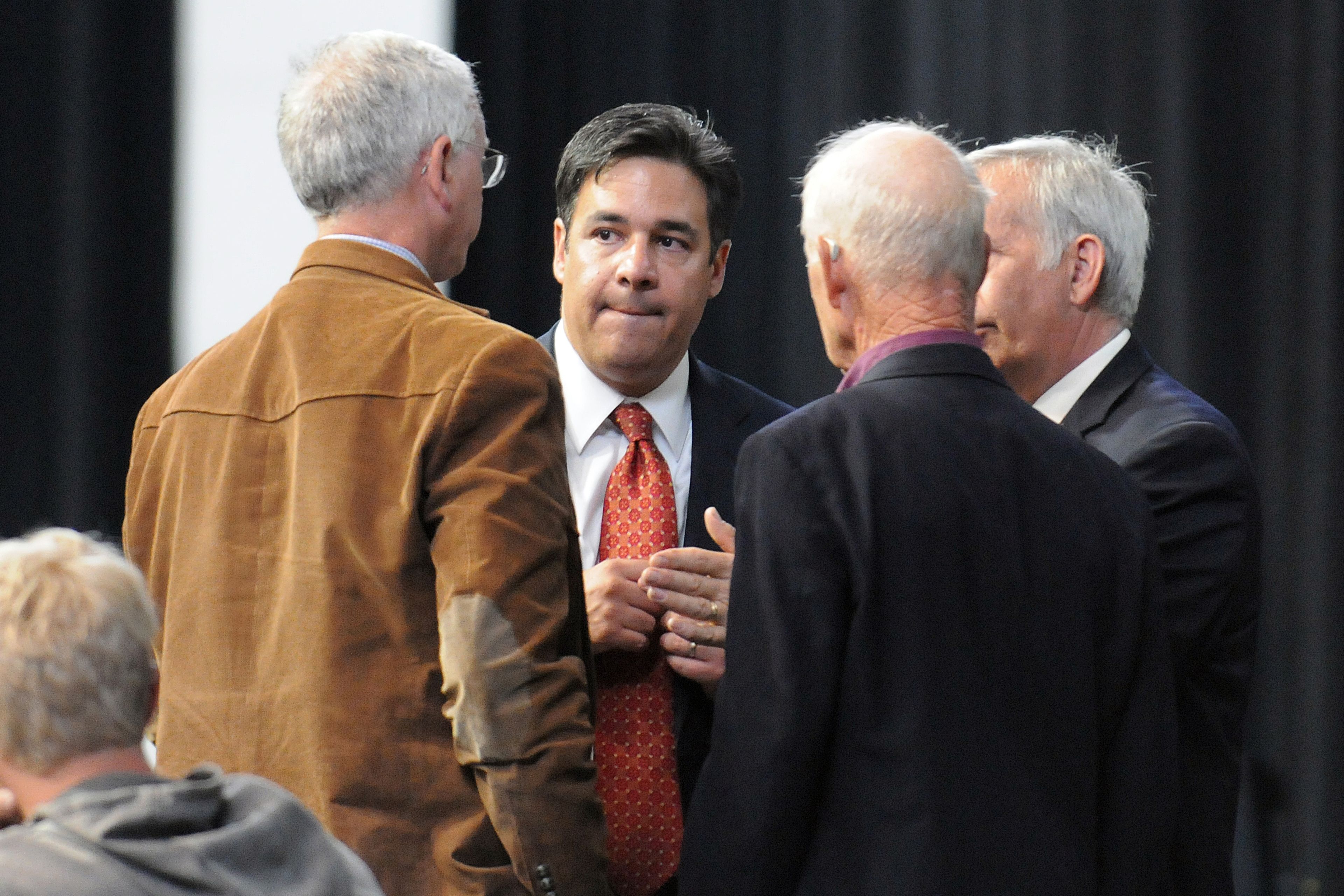 Rep. Raul Labrador listens to conventions parliamentarians as they try to resolve a motion on the floor Saturday, June 14, 2014.