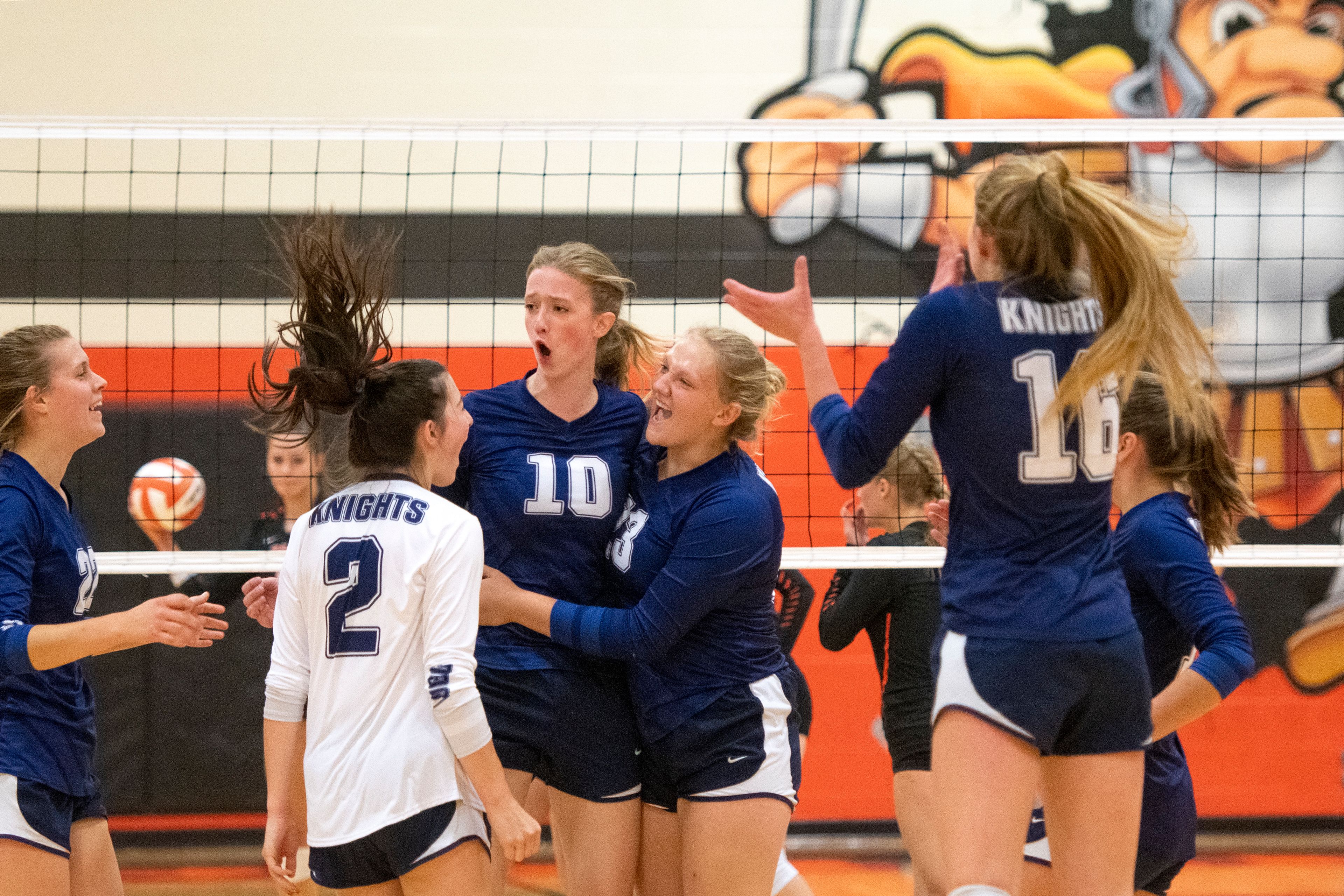 Logos players celebrate after scoring a point against Troy during a Whitepine League matchup at Troy High School on Tuesday.