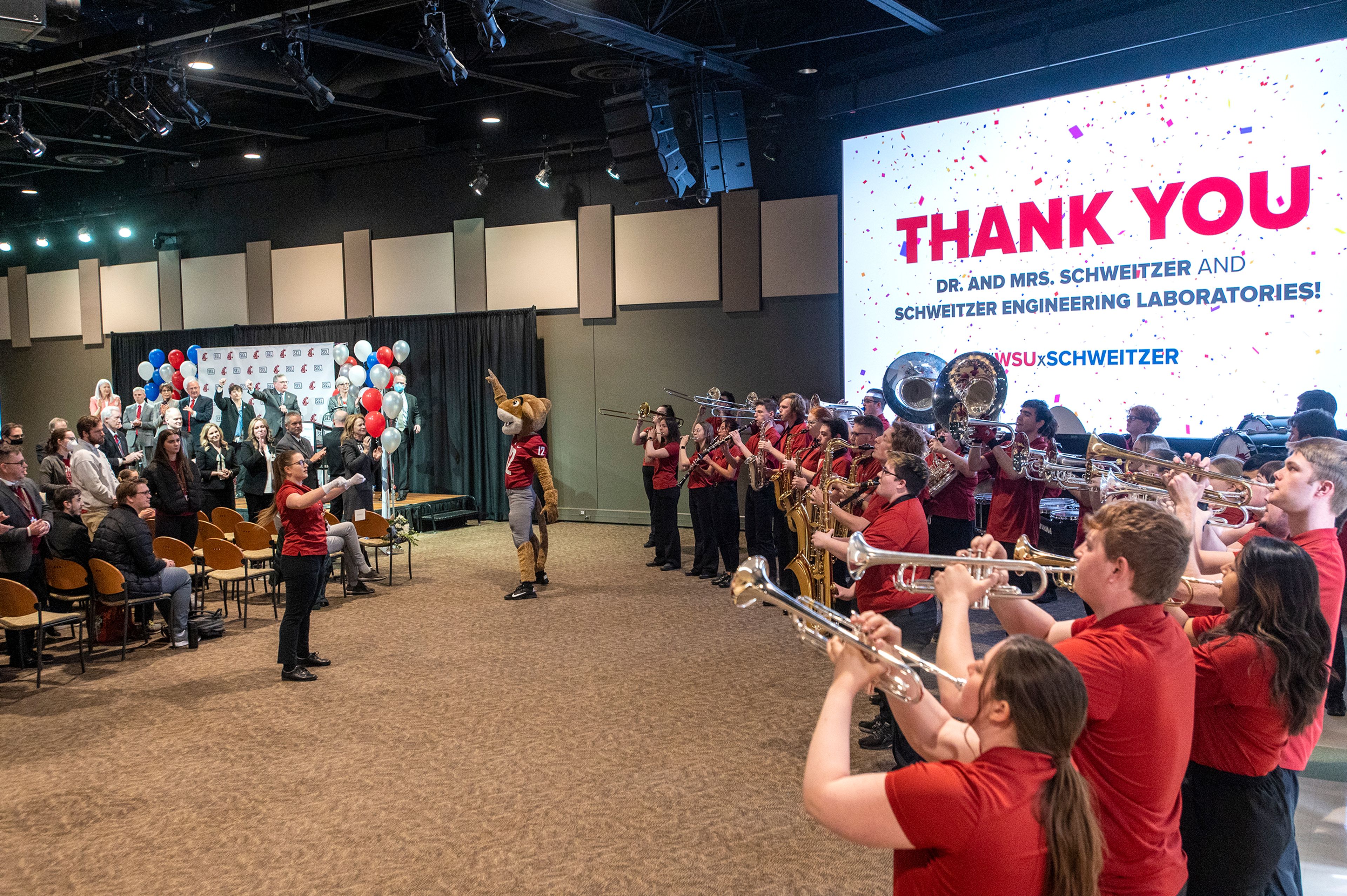 The Washington State University marching band performs at the announcement of a combined $20 million donation from Schweitzer Engineering Laboratories and Edmund and Beatriz Schweitzer at the SEL Event Center on Monday morning in Pullman.