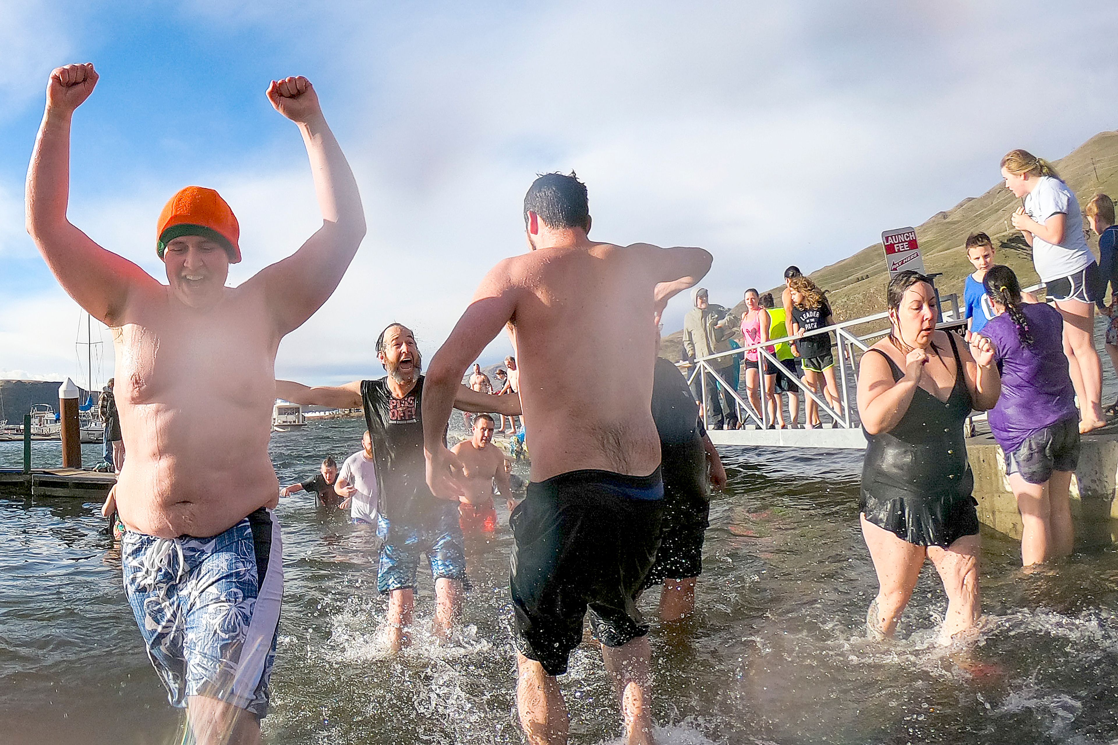 Swimmers celebrate after making out of the cold water and onto land after jumping into the Snake River for the 19th annual Polar Plunge in Clarkston on Wednesday.