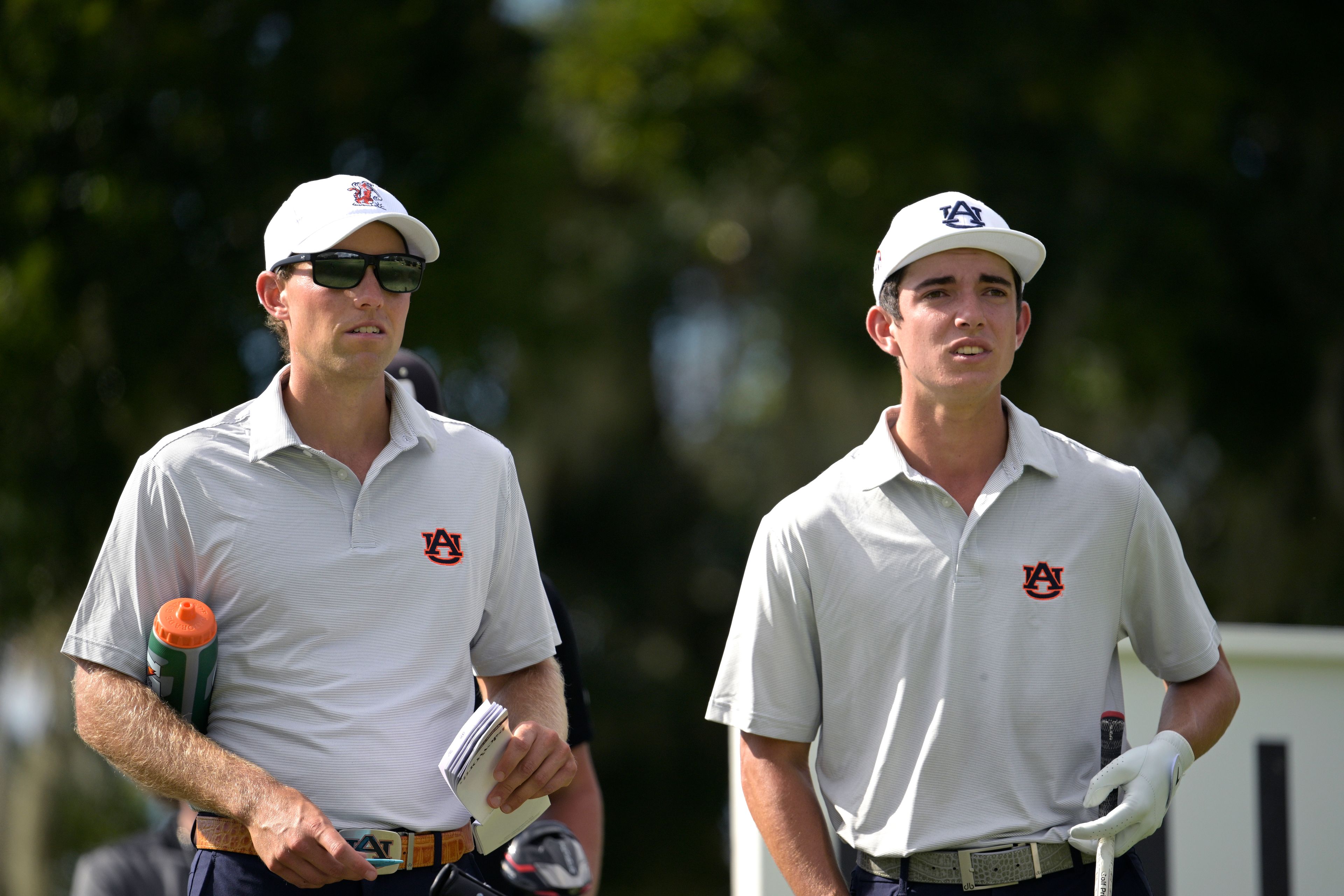 Auburn golf assistant coach Chris Williams, left, works with Brendan Valdes while Valdes waits to tee off on the 18th hole during an NCAA golf tournament, Monday, Oct. 24, 2022, in Windermere, Fla. (AP Photo/Phelan M. Ebenhack)